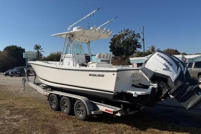 2002 Regulator 26 Forward Seating boat on trailer with twin Evinrude engines.