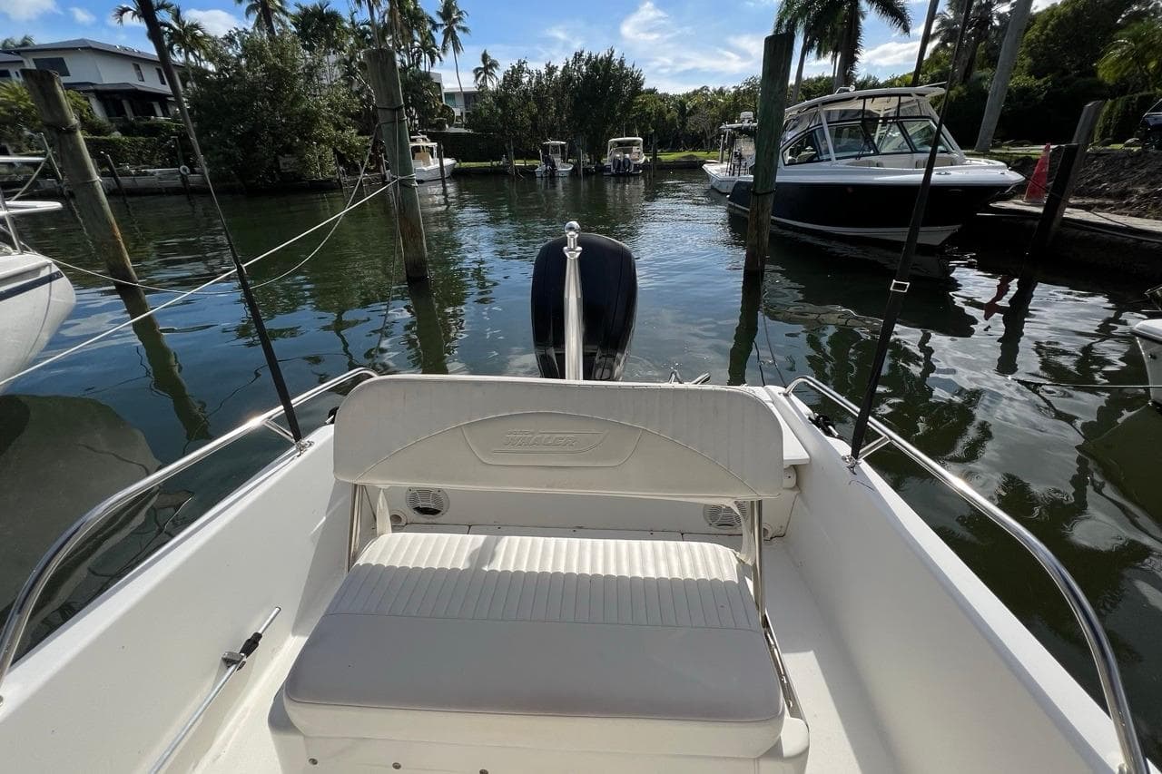 2016 Boston Whaler 170 Dauntless boat docked in a scenic marina setting.