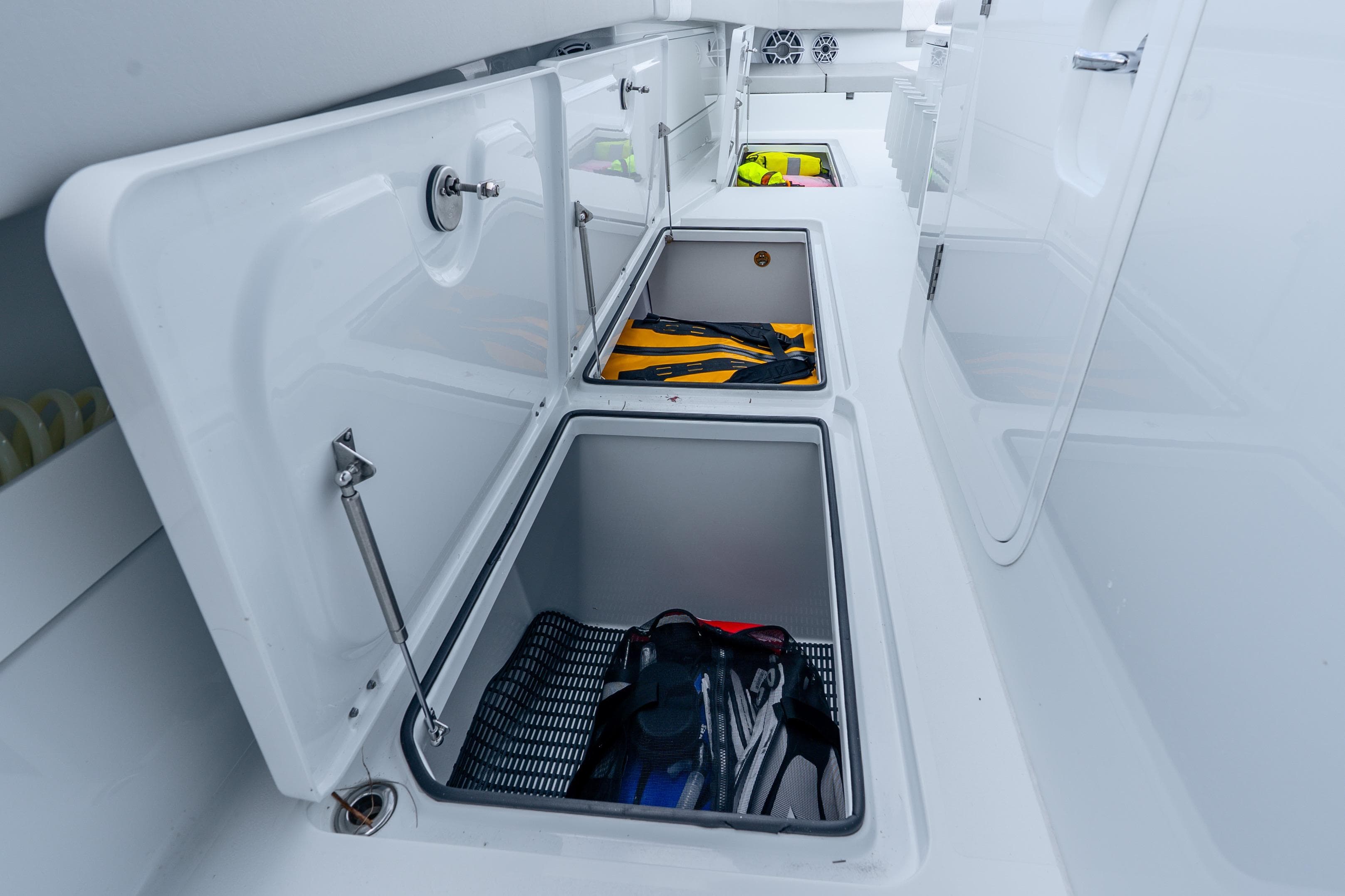 Open storage compartments on a 2024 Freeman 47 boat, showcasing organized gear storage.