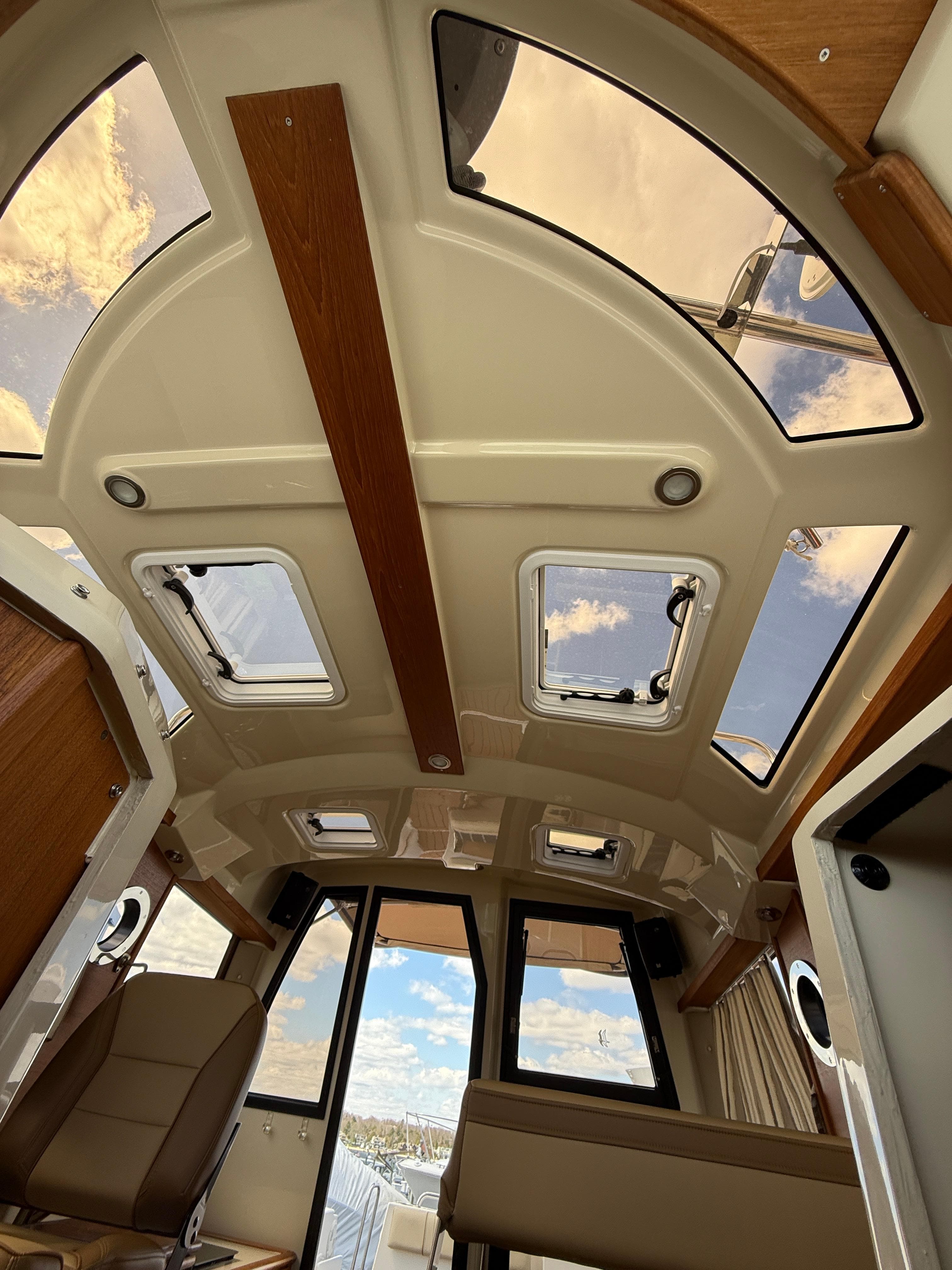 2023 Ranger Tugs R-25 interior with panoramic windows and modern design.