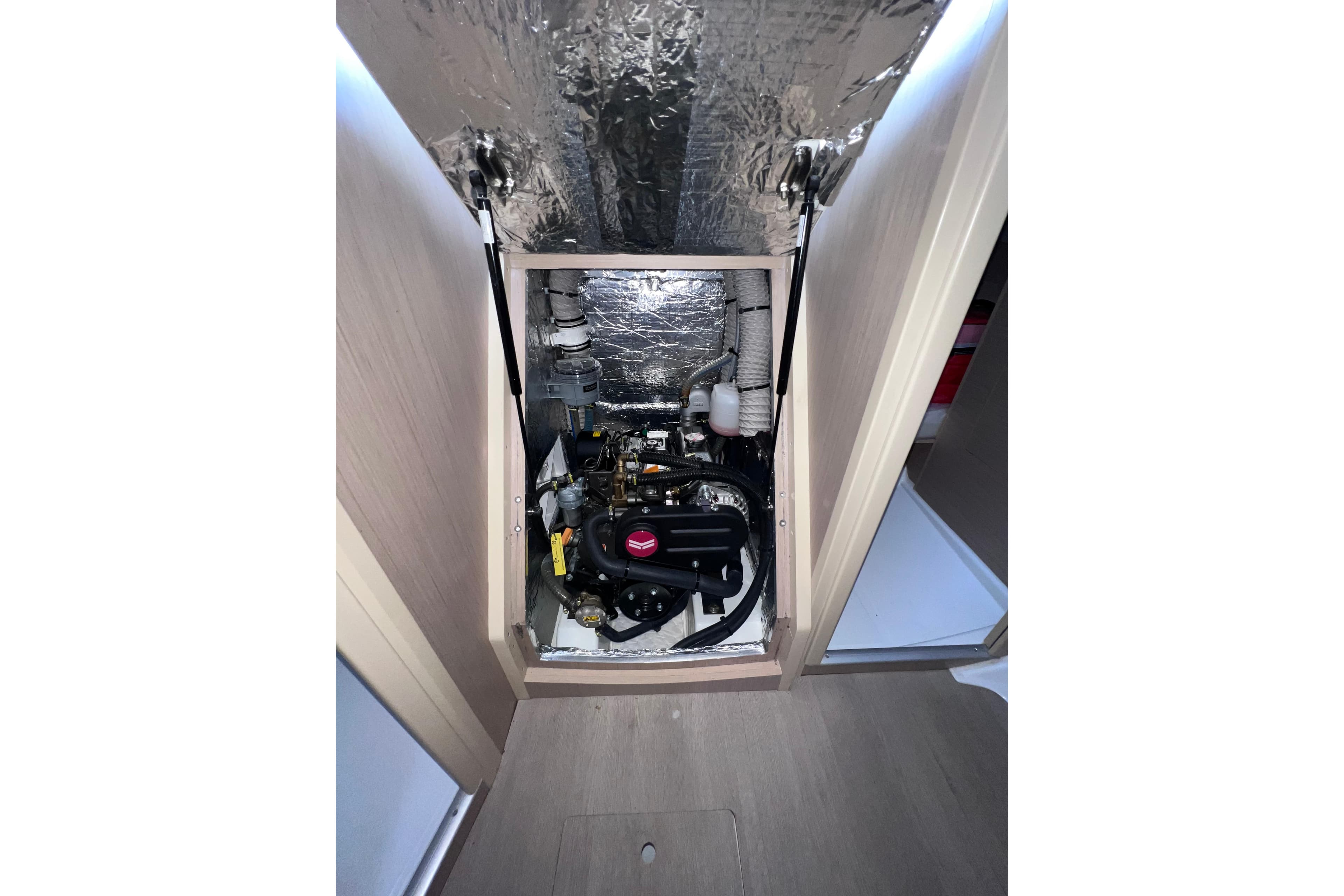 Engine compartment of 2024 Beneteau Oceanis 30.1 sailboat, showcasing mechanical components.