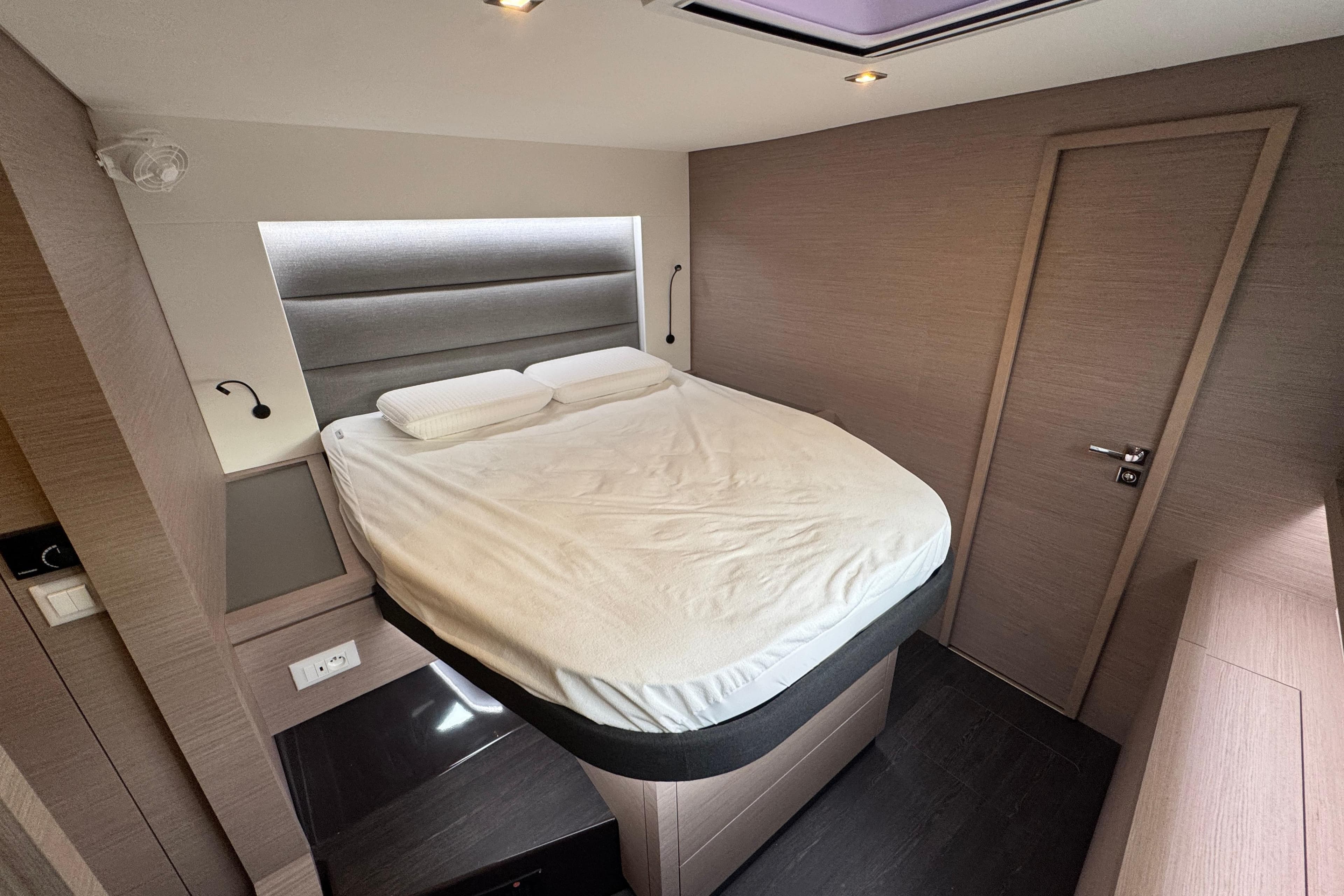 Luxurious bedroom interior of 2021 Fountaine Pajot Saona 47 catamaran, featuring modern design.