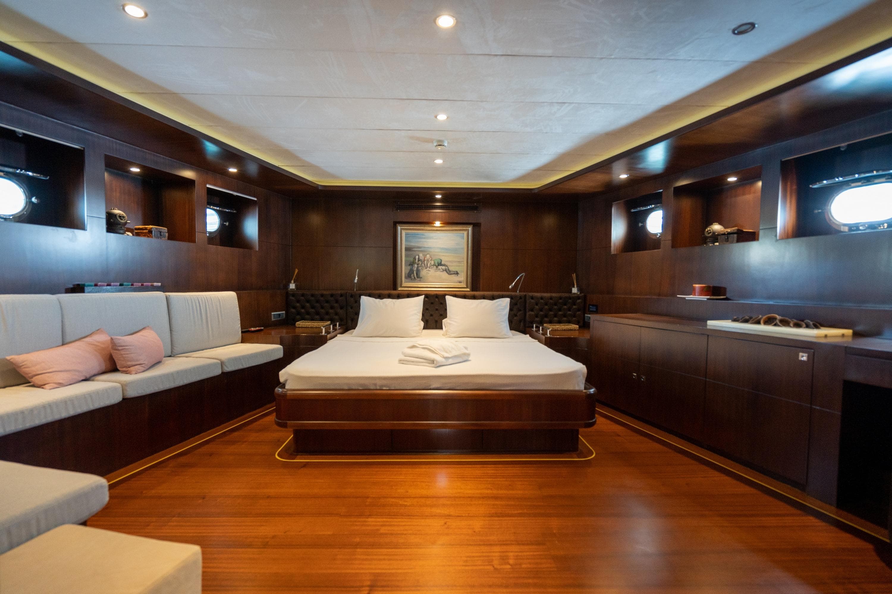Luxurious 2009 Ada Yacht Ketch cabin with elegant wood interior and cozy bedding.