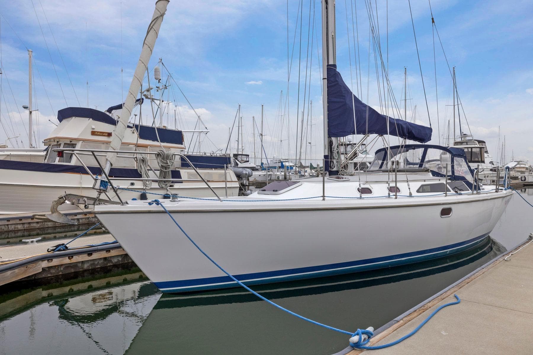 2004 Catalina 36 MkII sailboat docked at marina, featuring sleek design and blue accents.