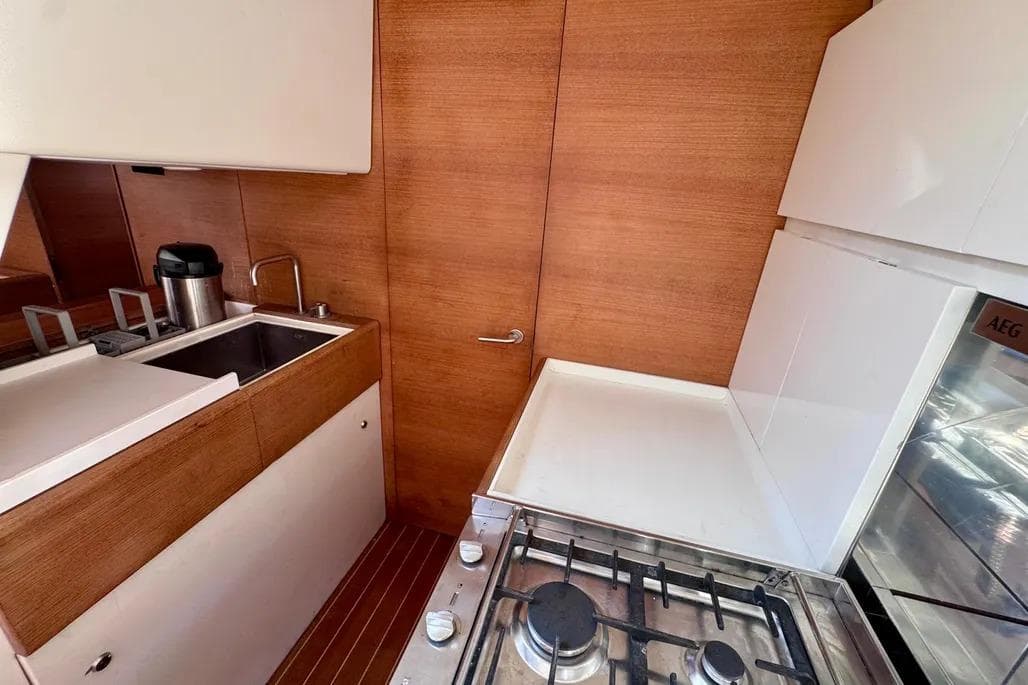 Modern galley kitchen in 2009 Nautor Swan 60 FD yacht with wood finish.