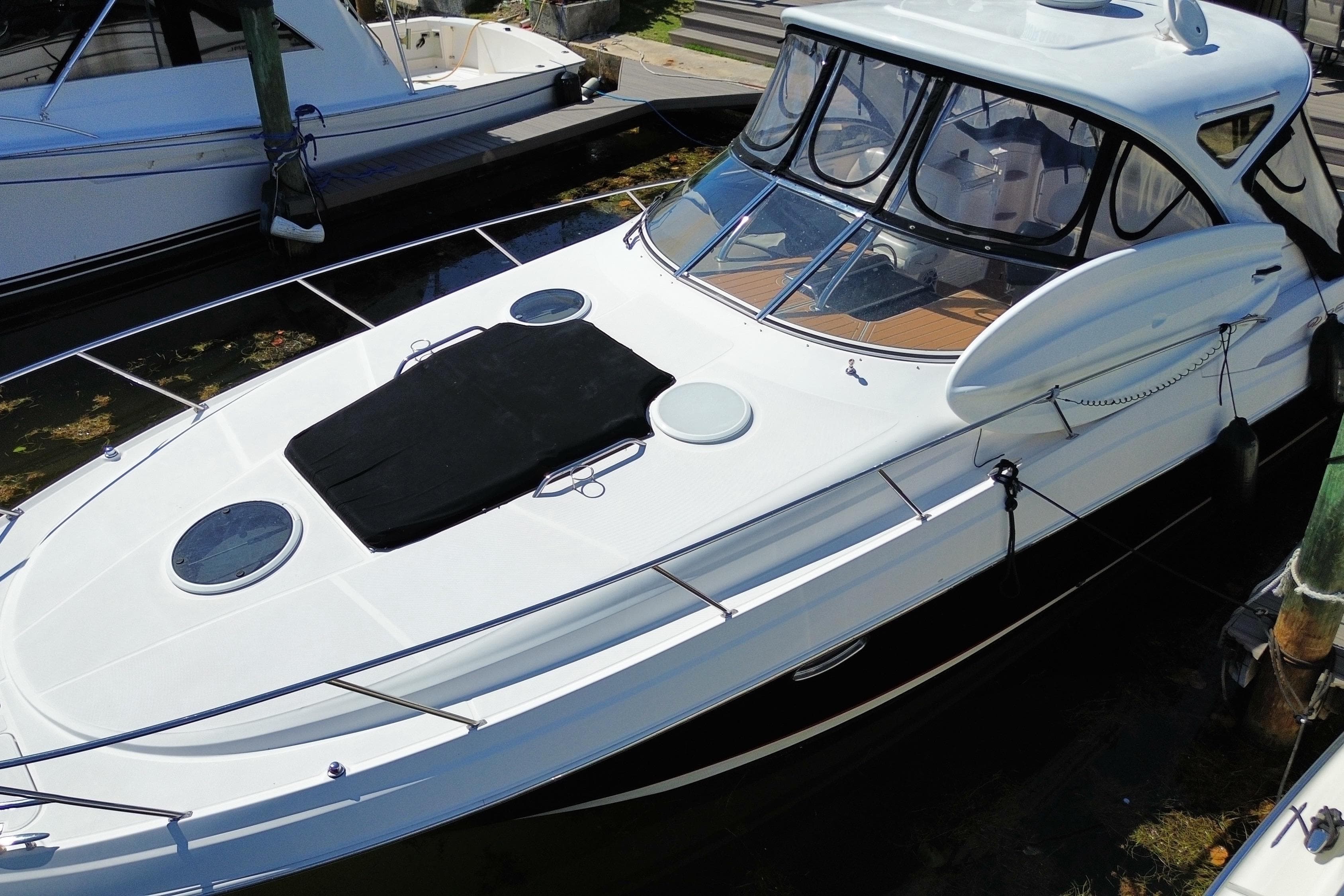 2006 Regal Commodore 3560 IB yacht docked, featuring sleek design and spacious deck.