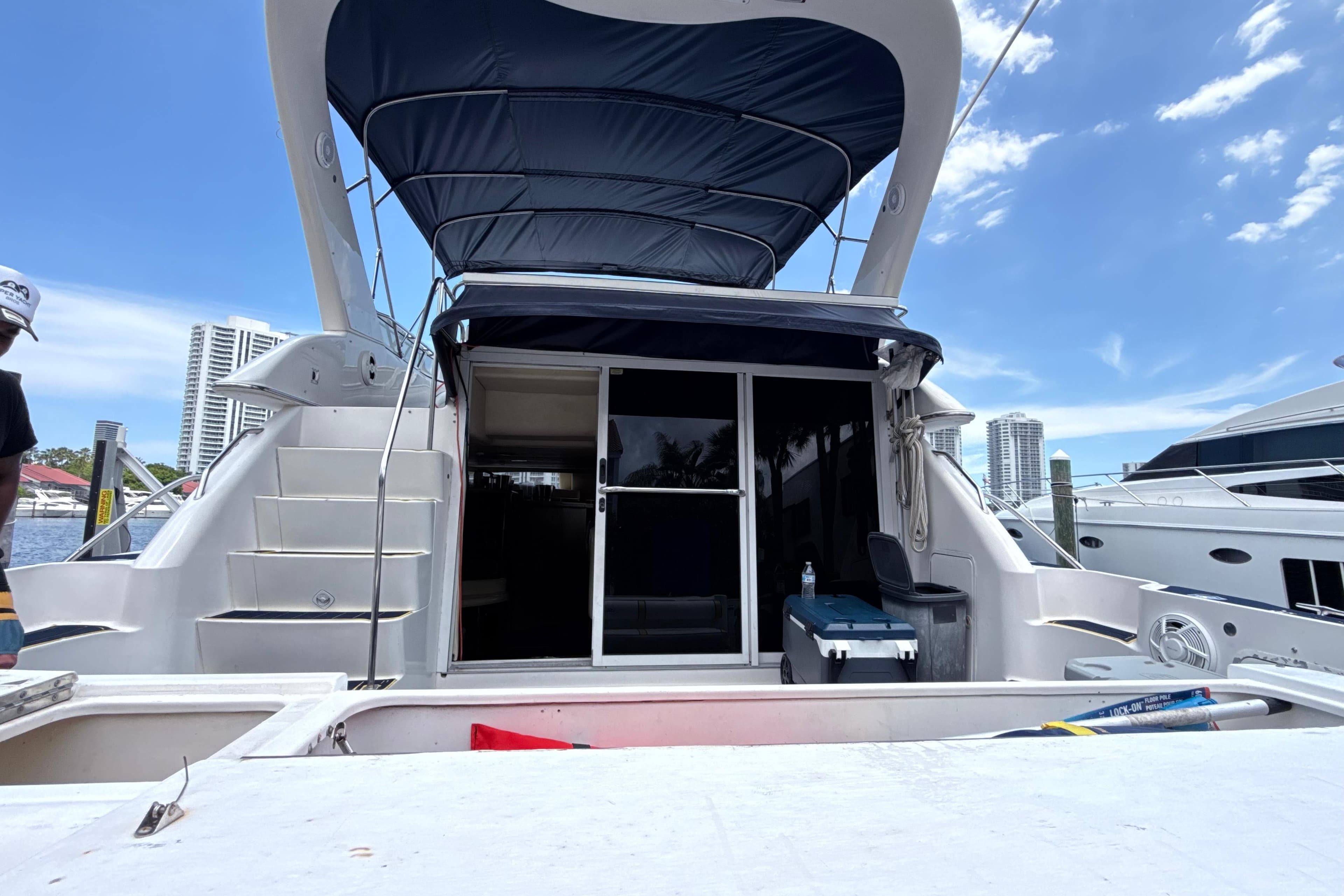 2001 Sea Ray 450 Express Bridge yacht docked, featuring spacious deck and canopy.