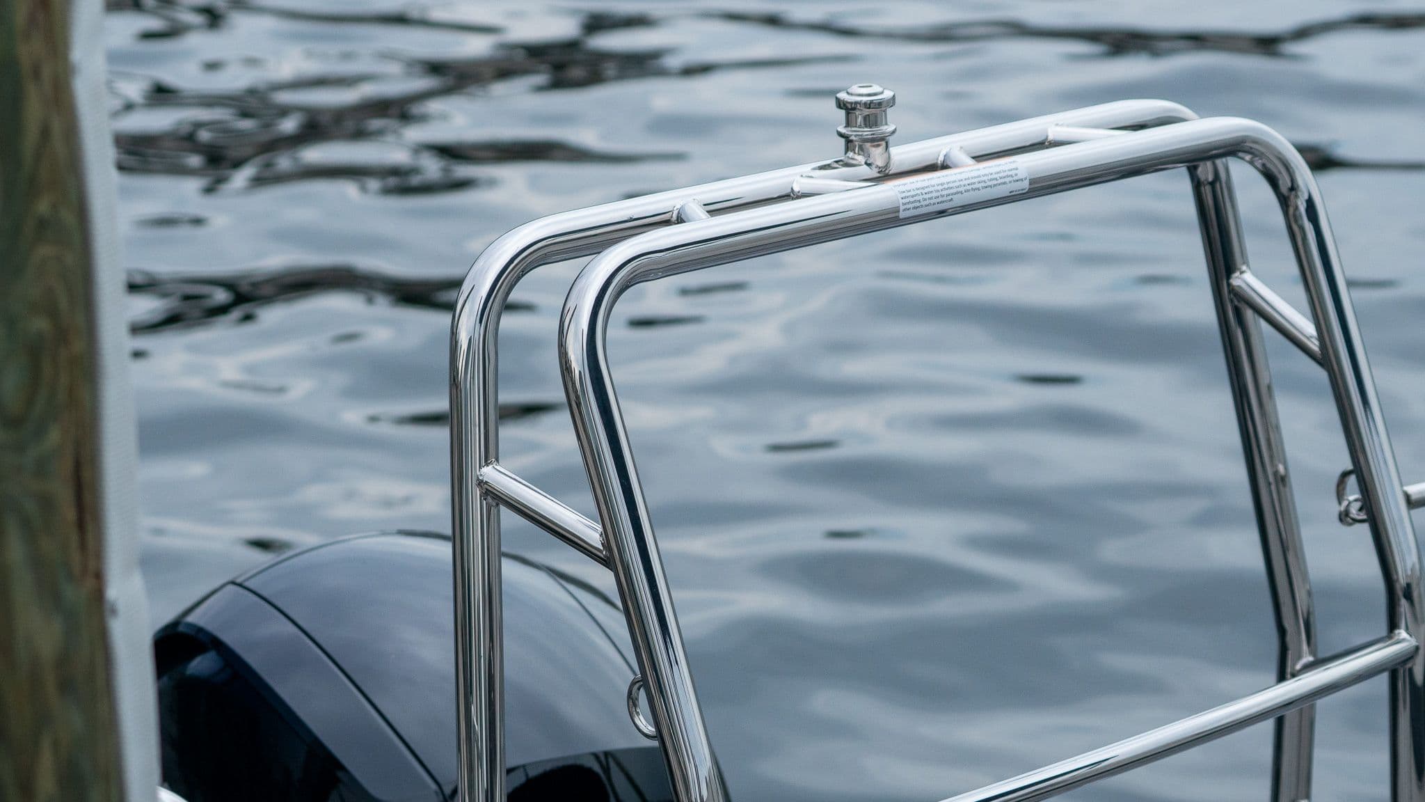 Harris Cruiser 230, 2026, by water with stainless steel railing.