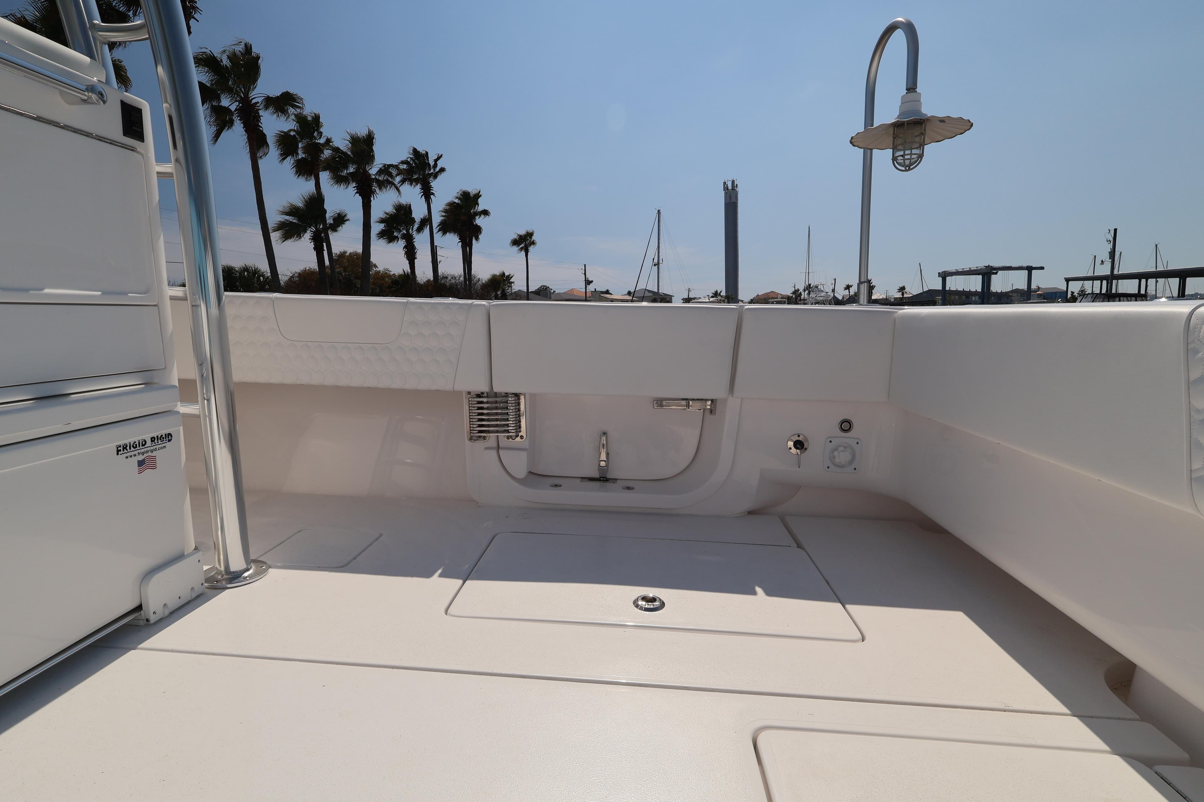 2026 Contender 44 CB boat deck with palm trees and marina background.