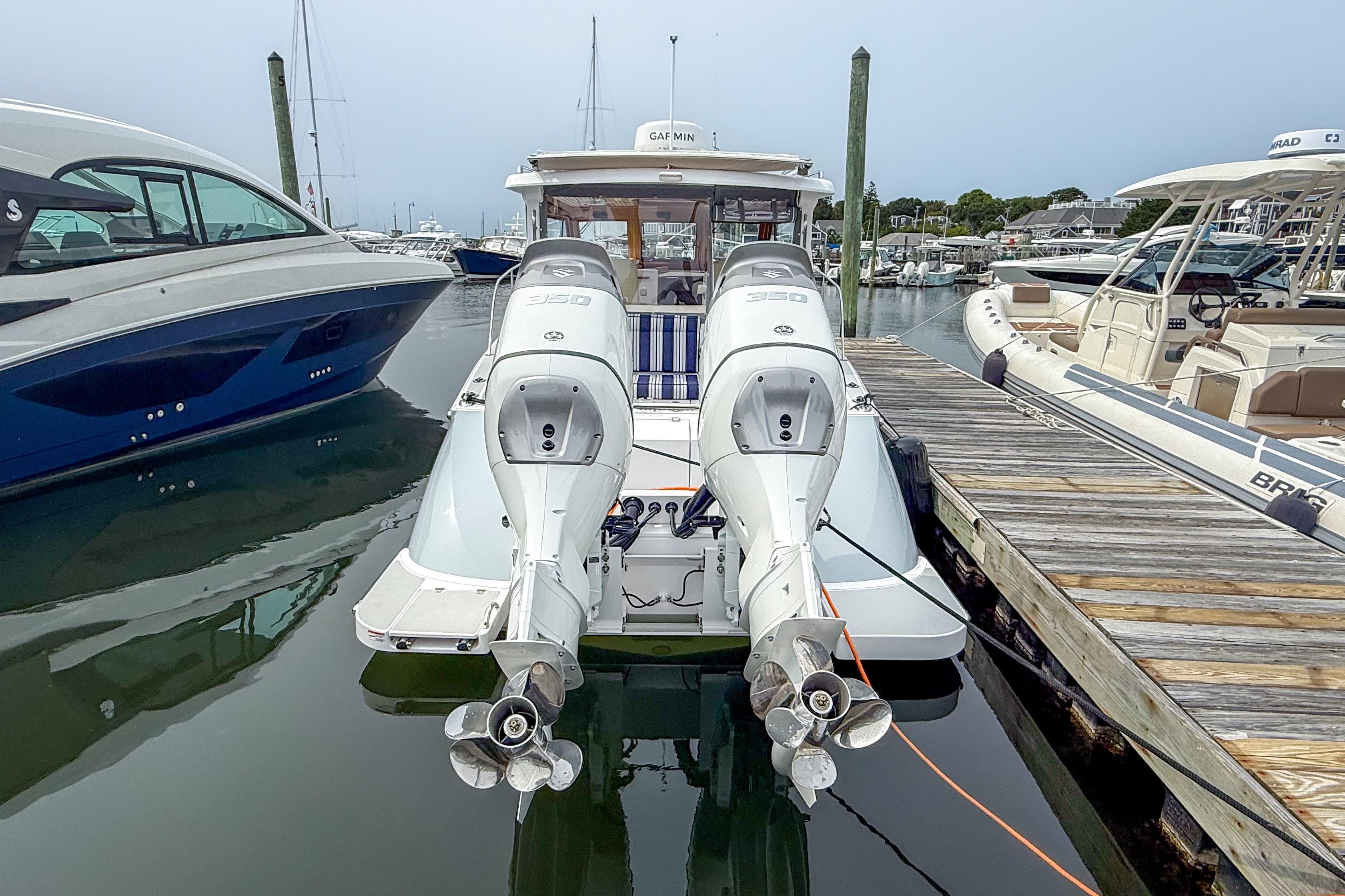2024 True North 34 boat docked with dual outboard engines in a marina.