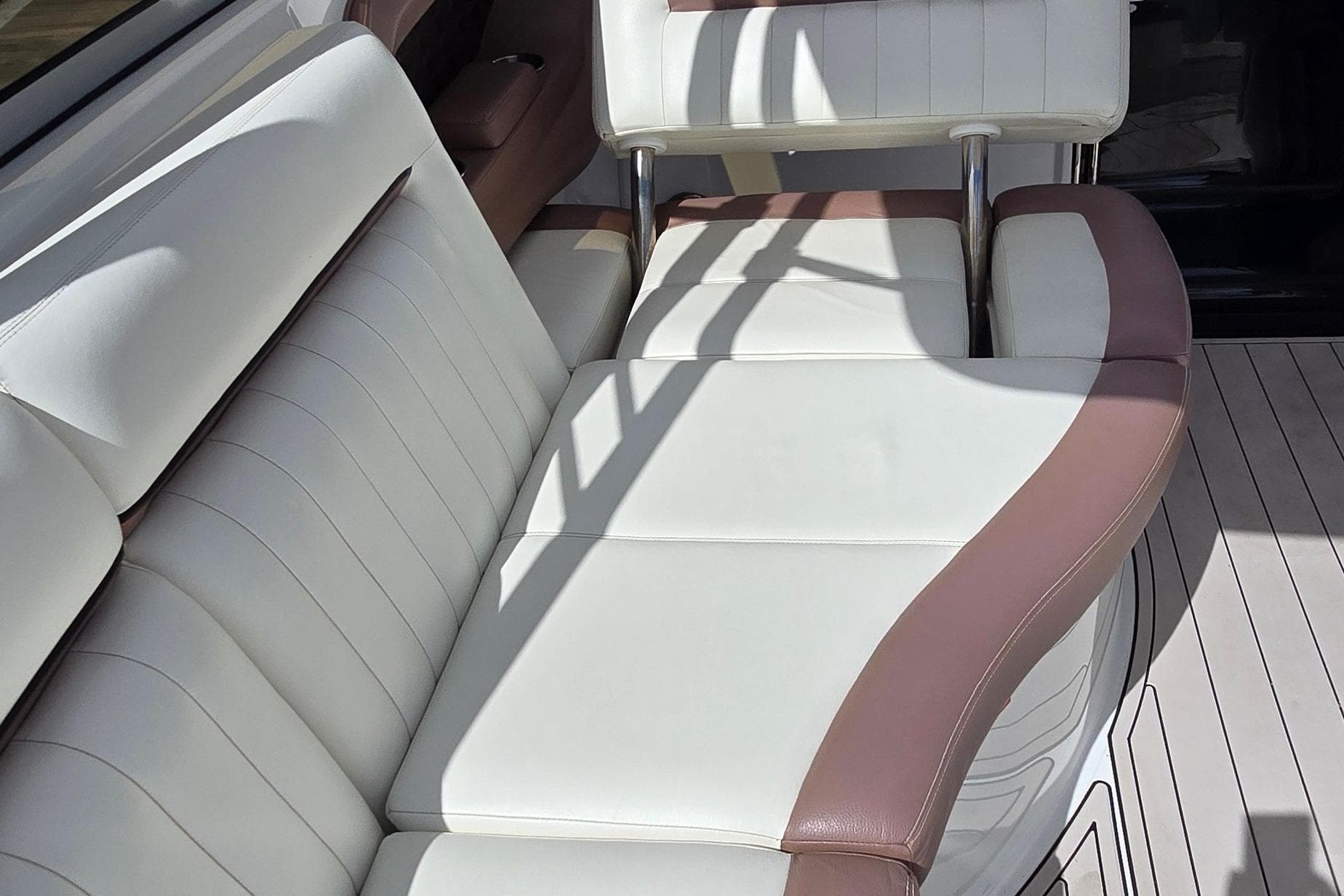 Luxurious seating on a 2011 Cobalt 323 boat with white and brown upholstery.