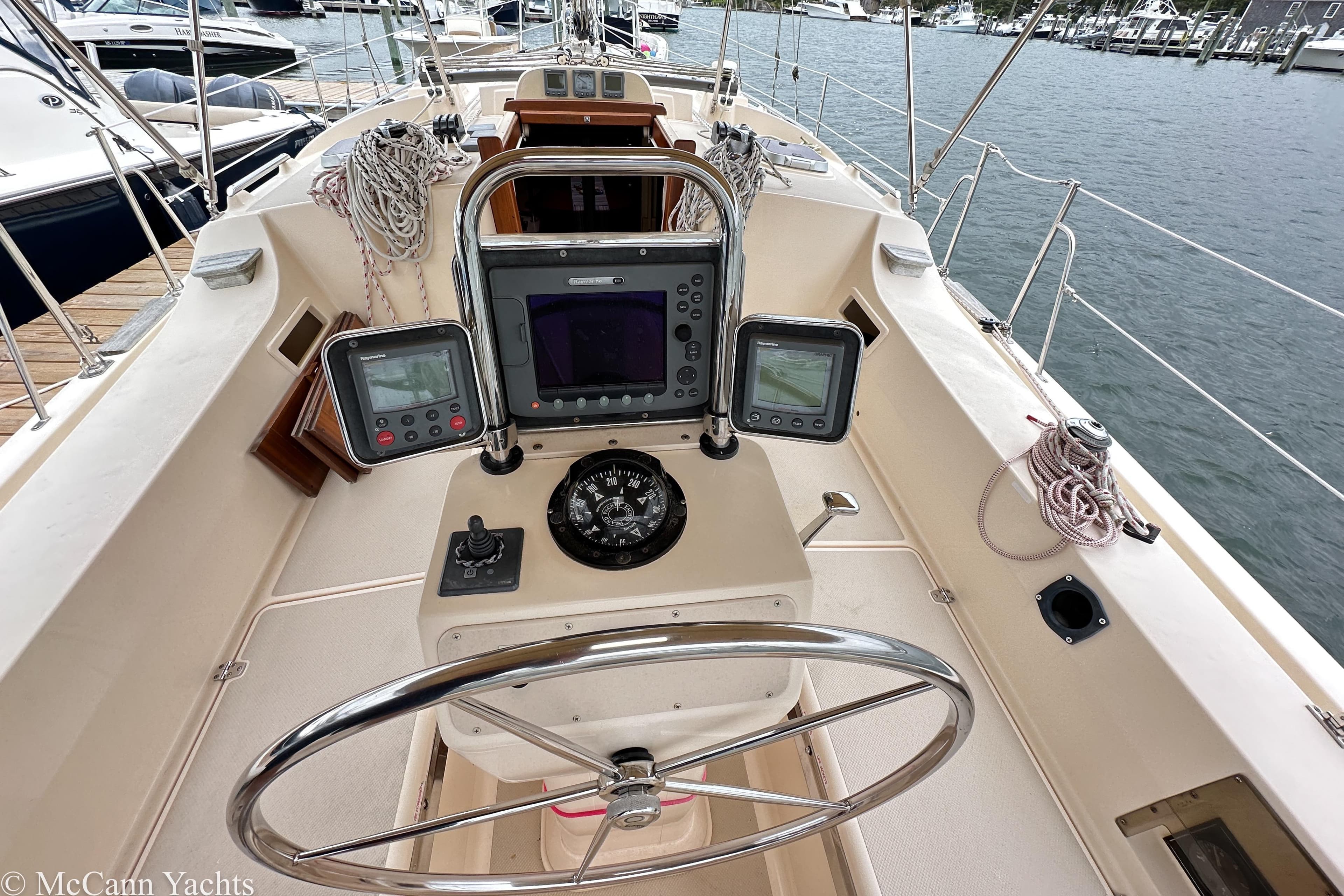 2010 Island Packet Estero yacht cockpit with navigation instruments and steering wheel.