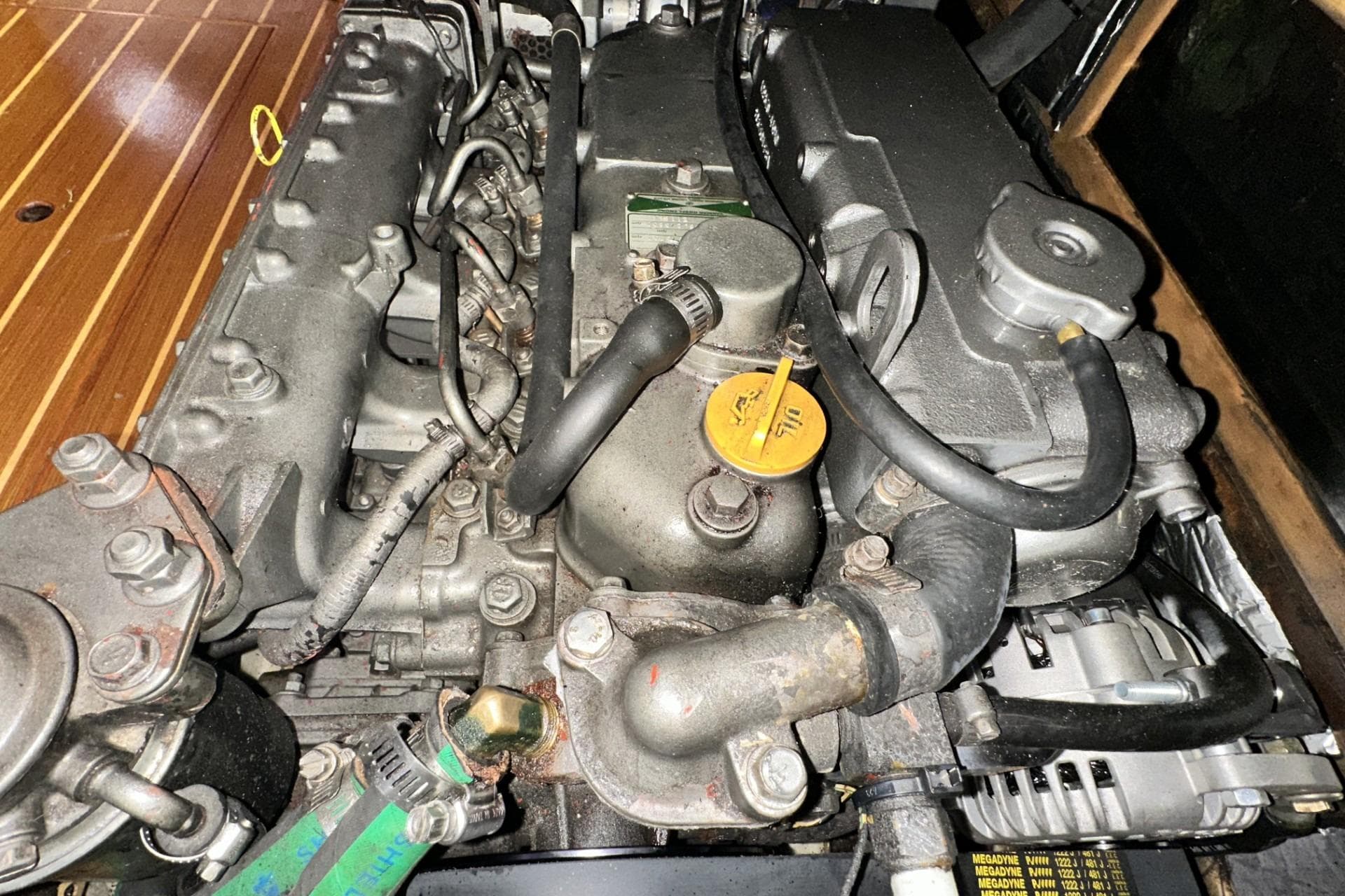 Engine of a 2002 Hunter 466 boat, showcasing mechanical components and hoses.