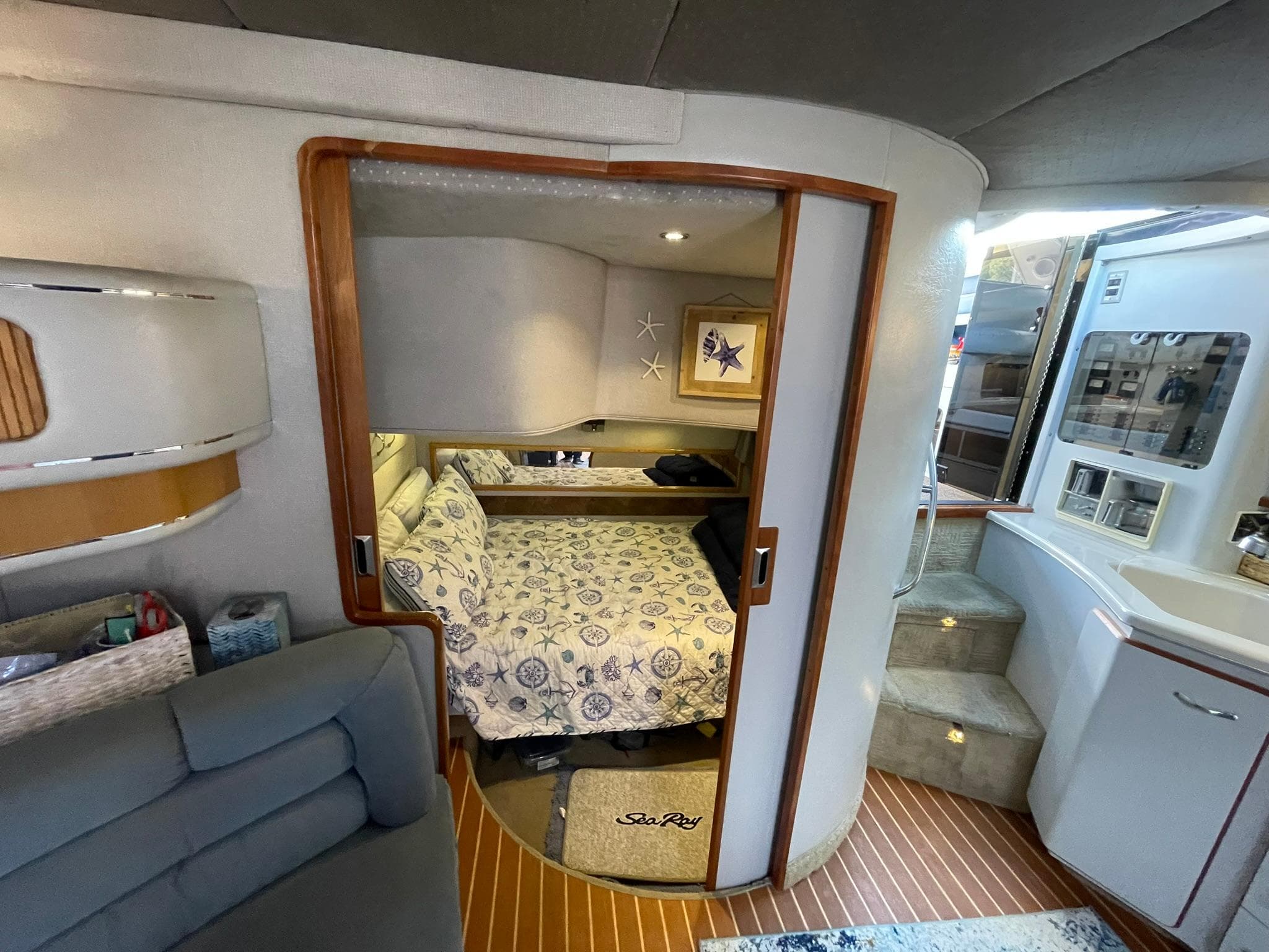 1989 Sea Ray 420 interior with cozy bedroom, wooden accents, and modern amenities.