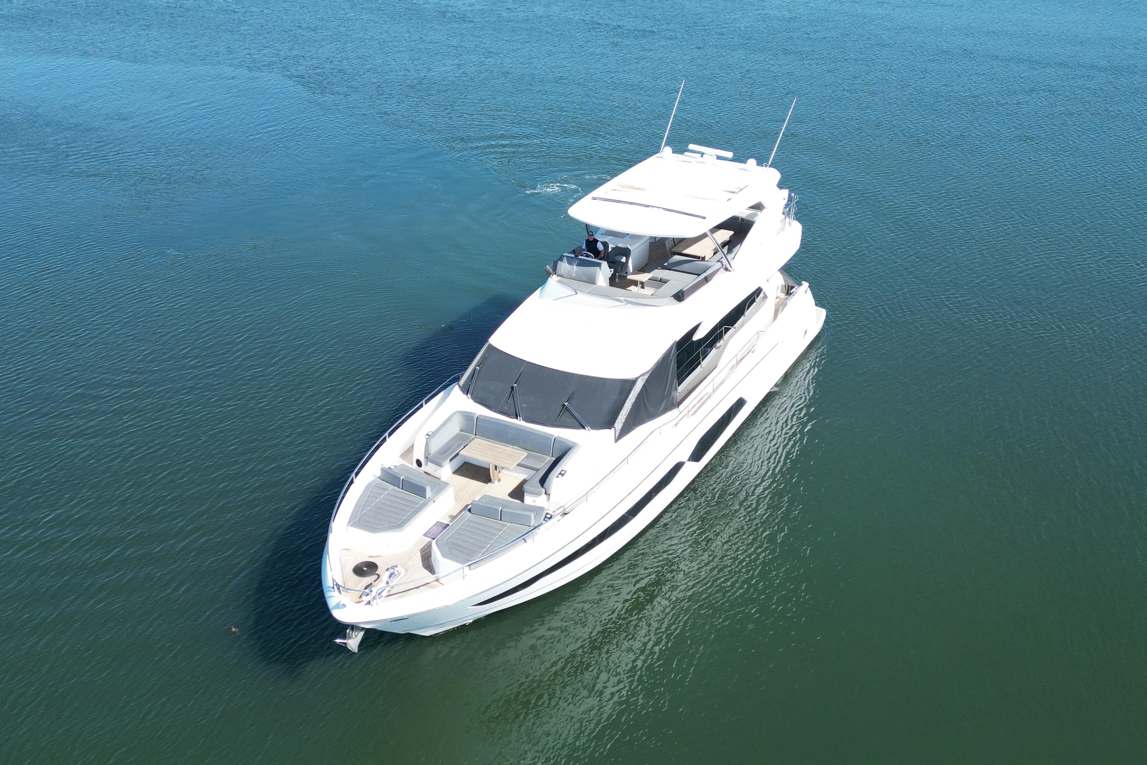 2018 Sunseeker 76 Yacht cruising on calm blue waters.