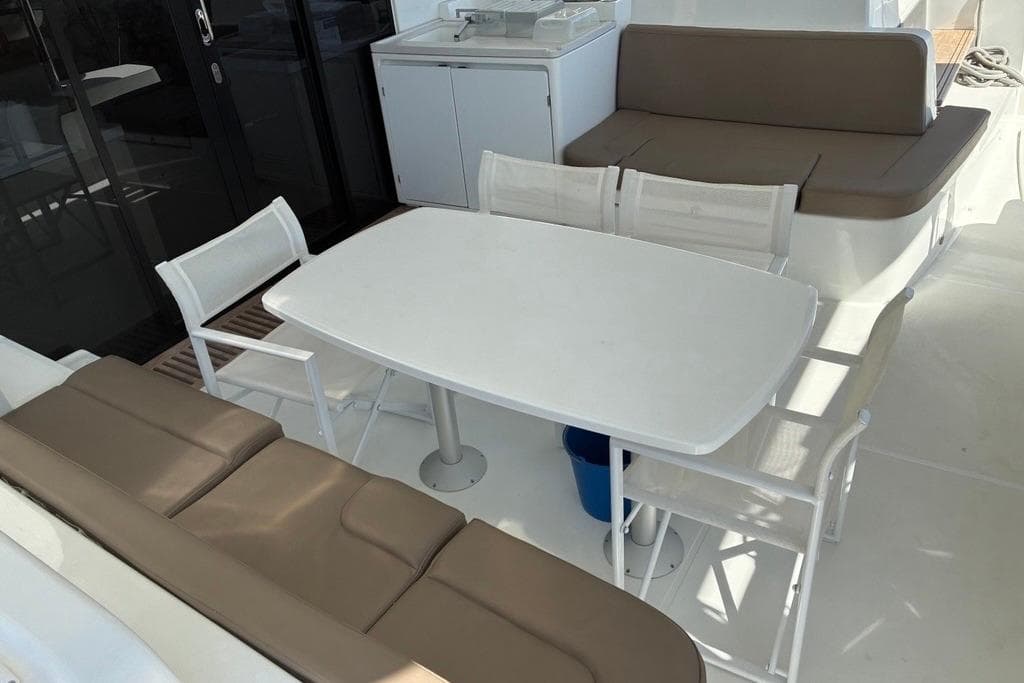2024 Lagoon 51 yacht deck with seating and dining area.