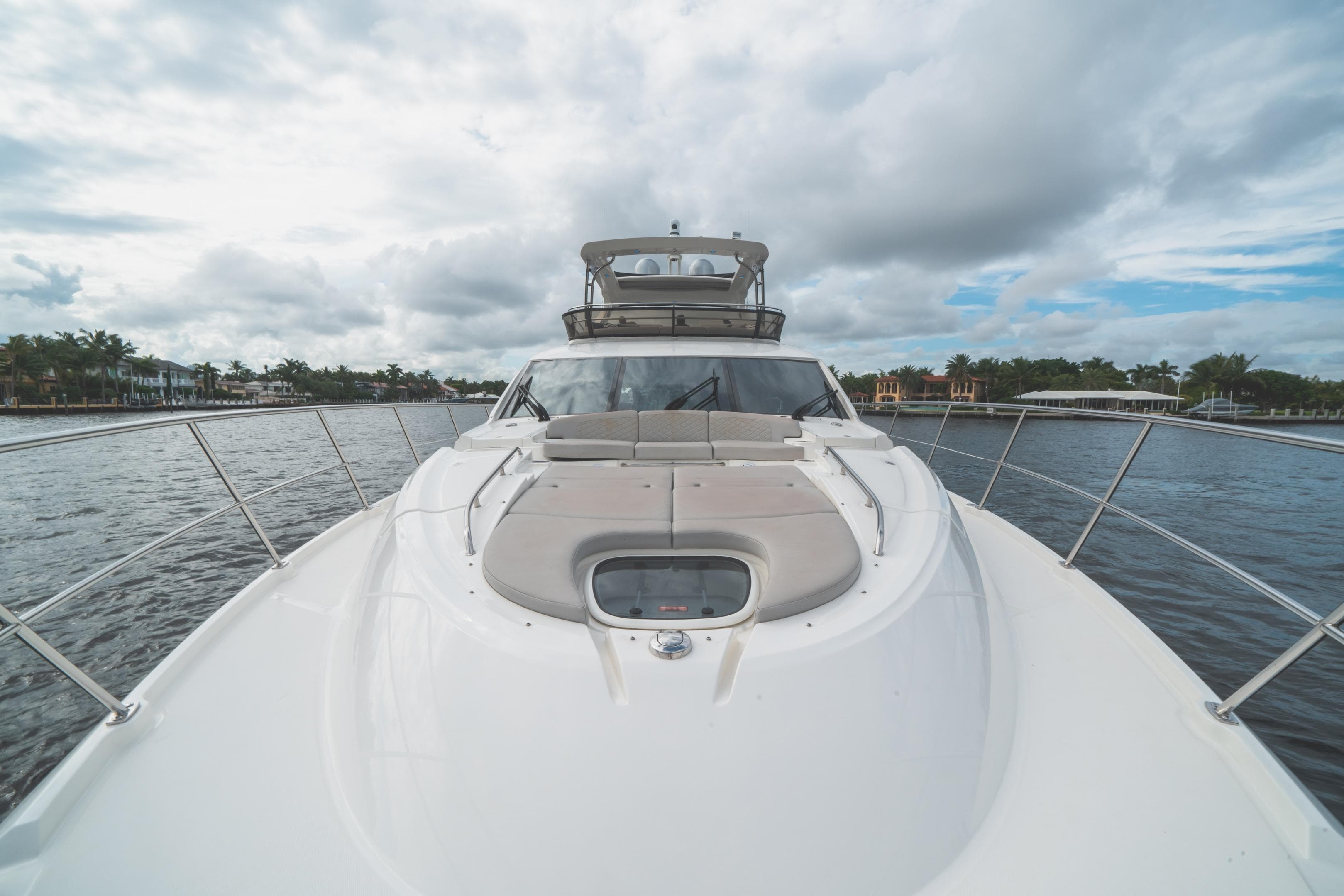 2017 Sea Ray L650 Fly yacht on water under cloudy sky.