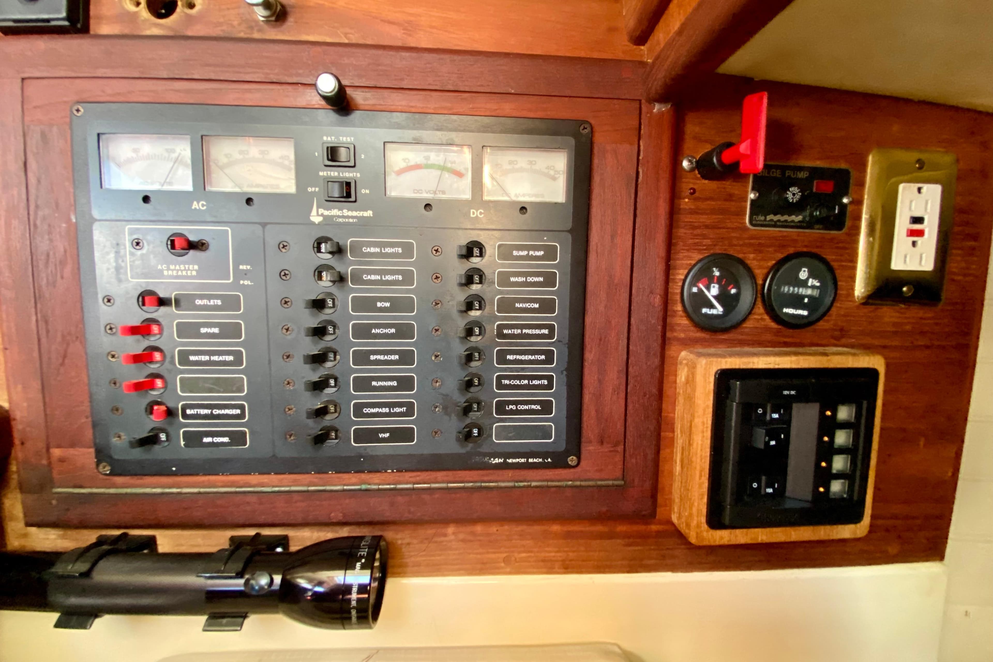 Electrical control panel of a 1993 Pacific Seacraft 34 sailboat with switches and gauges.