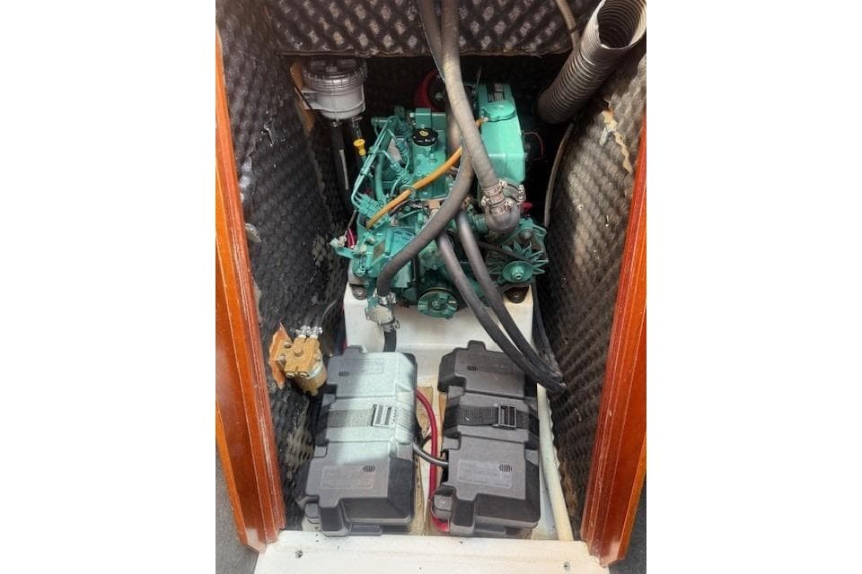 Engine compartment of 2002 Beneteau First 36.7 sailboat, featuring a compact marine engine.