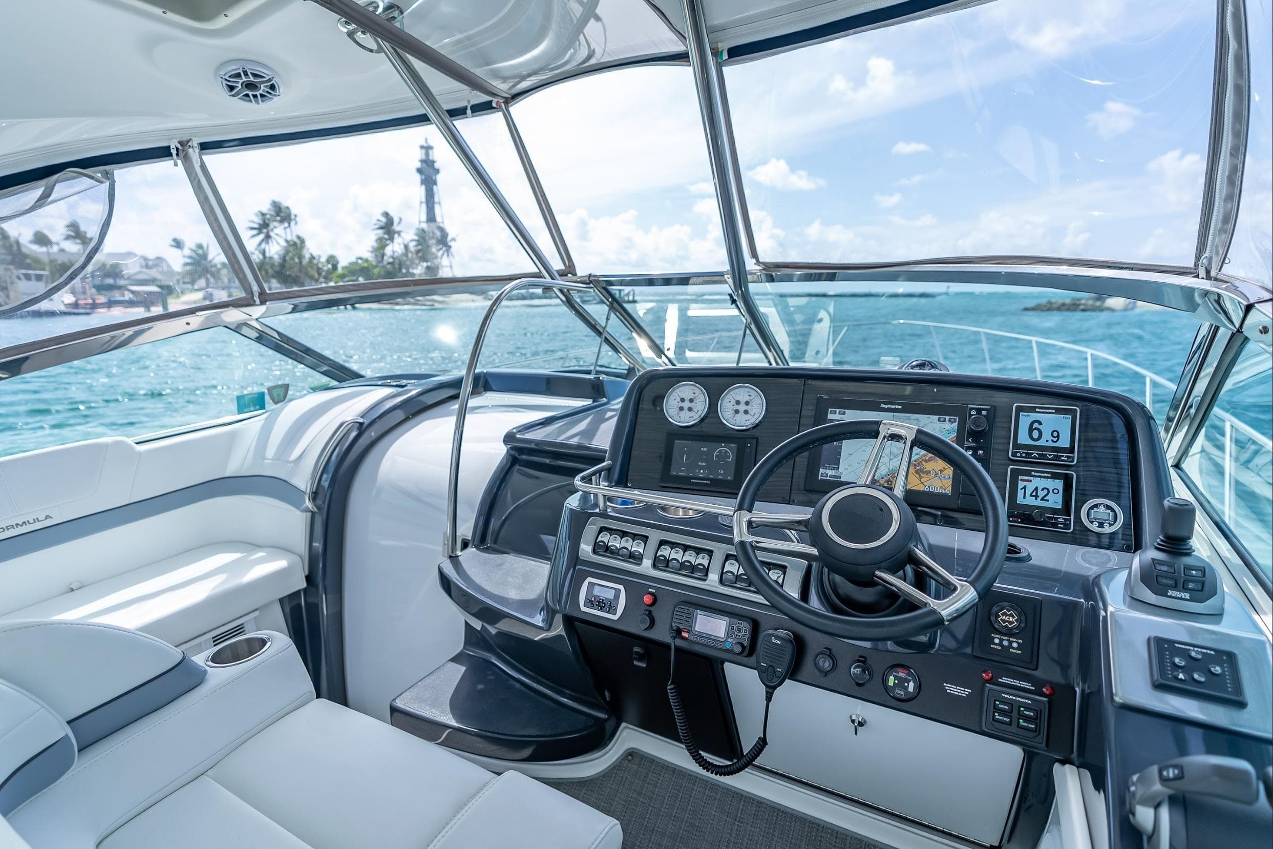 2022 Formula 40 Performance Cruiser helm with ocean view and lighthouse in background.