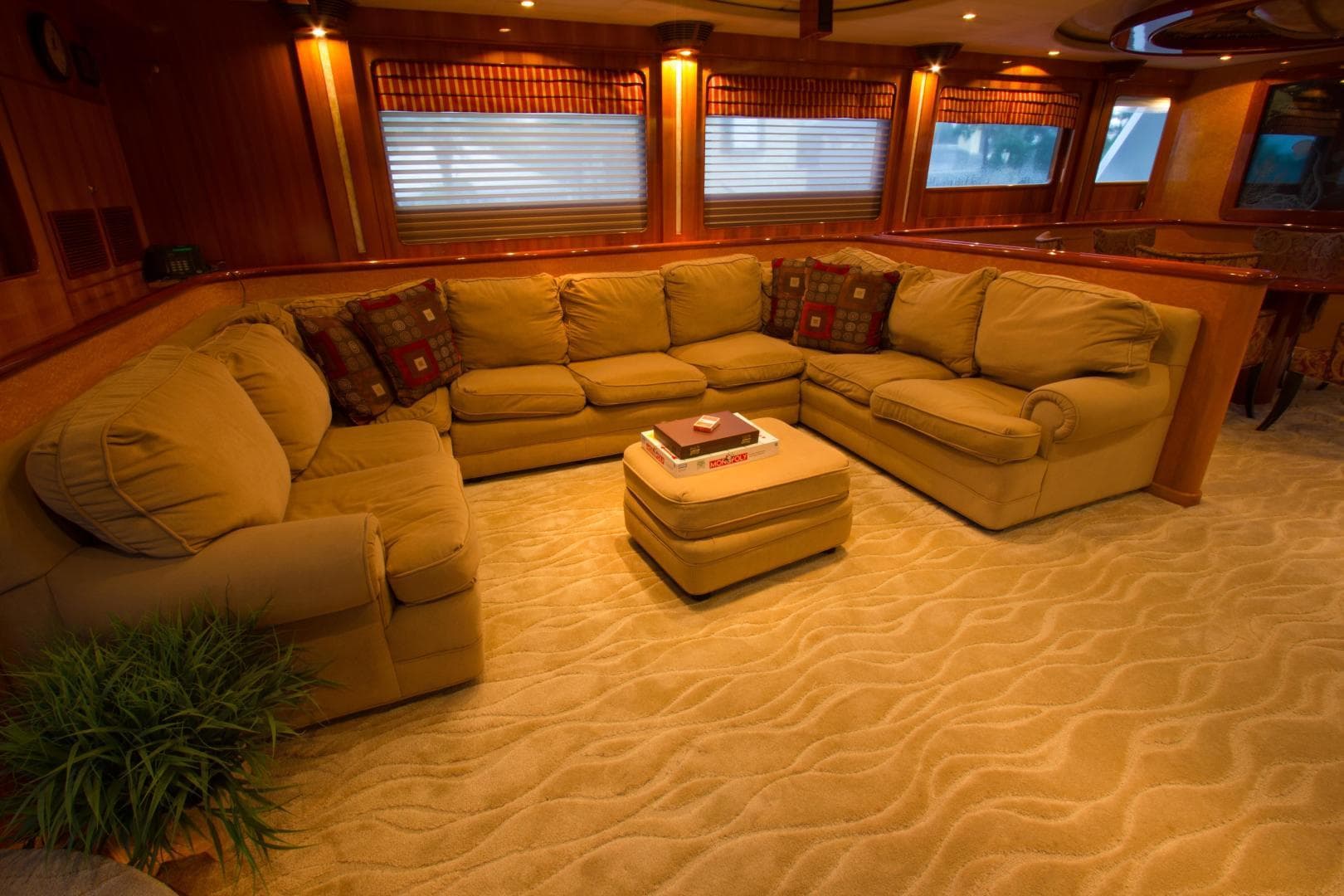 Luxurious interior of a 2002 President 100 Motor Yacht with plush seating and elegant decor.