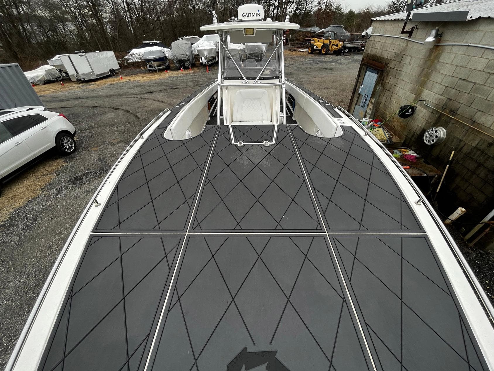 2011 Fountain 38 CC Tournament Edition boat with sleek deck design in a storage yard.