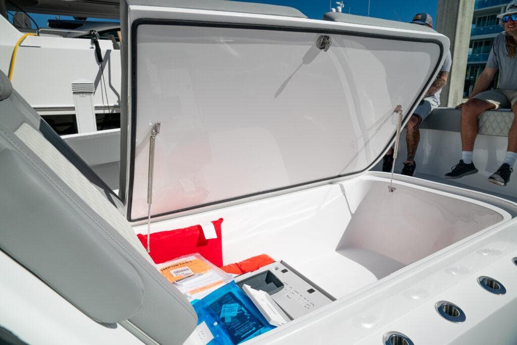 Open storage compartment on 2026 Front Runner 37 Catamaran, showcasing spacious interior and accessories.