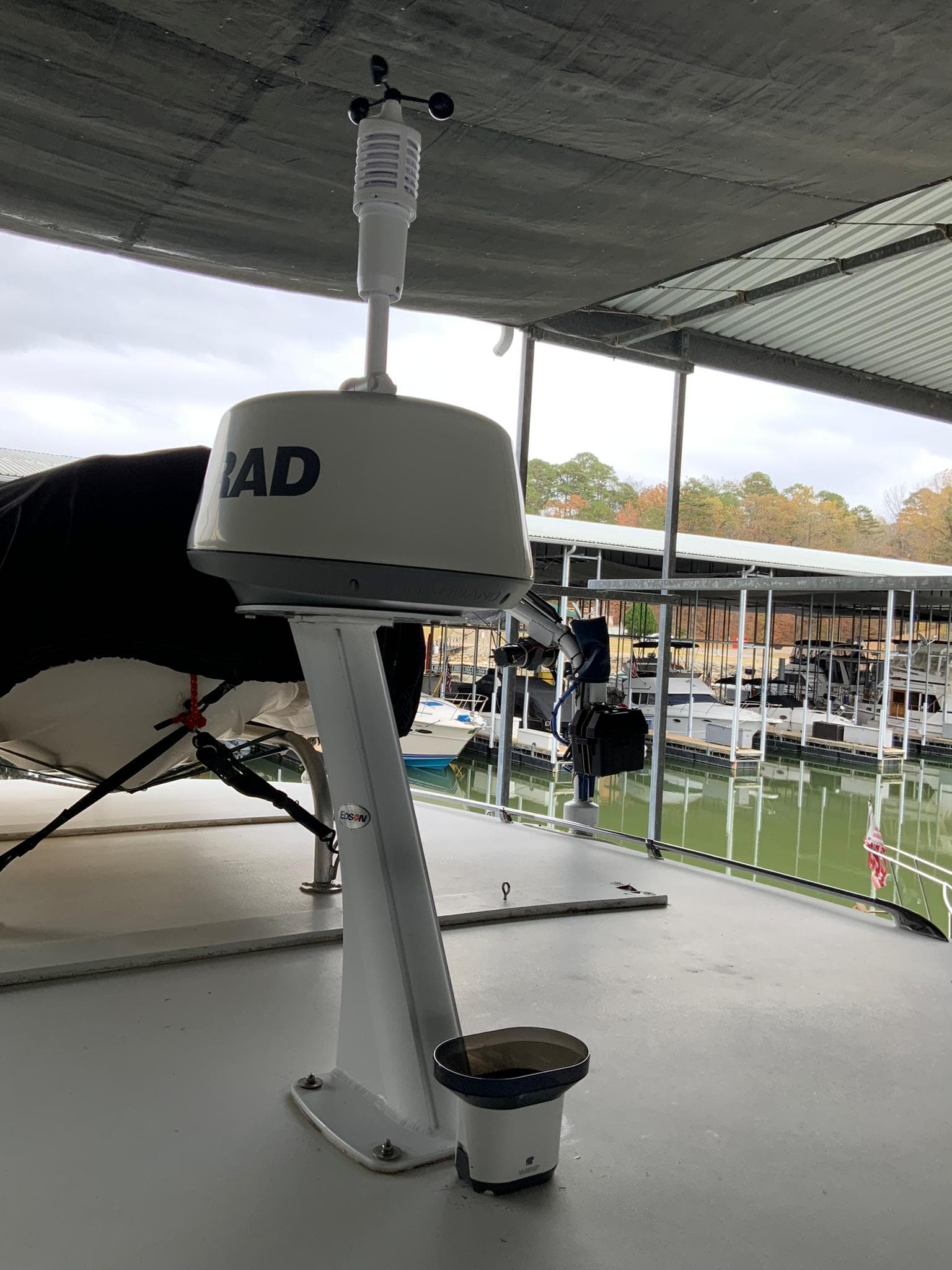 Radar equipment on a 1969 Hatteras 41 Double Cabin yacht under a marina roof.