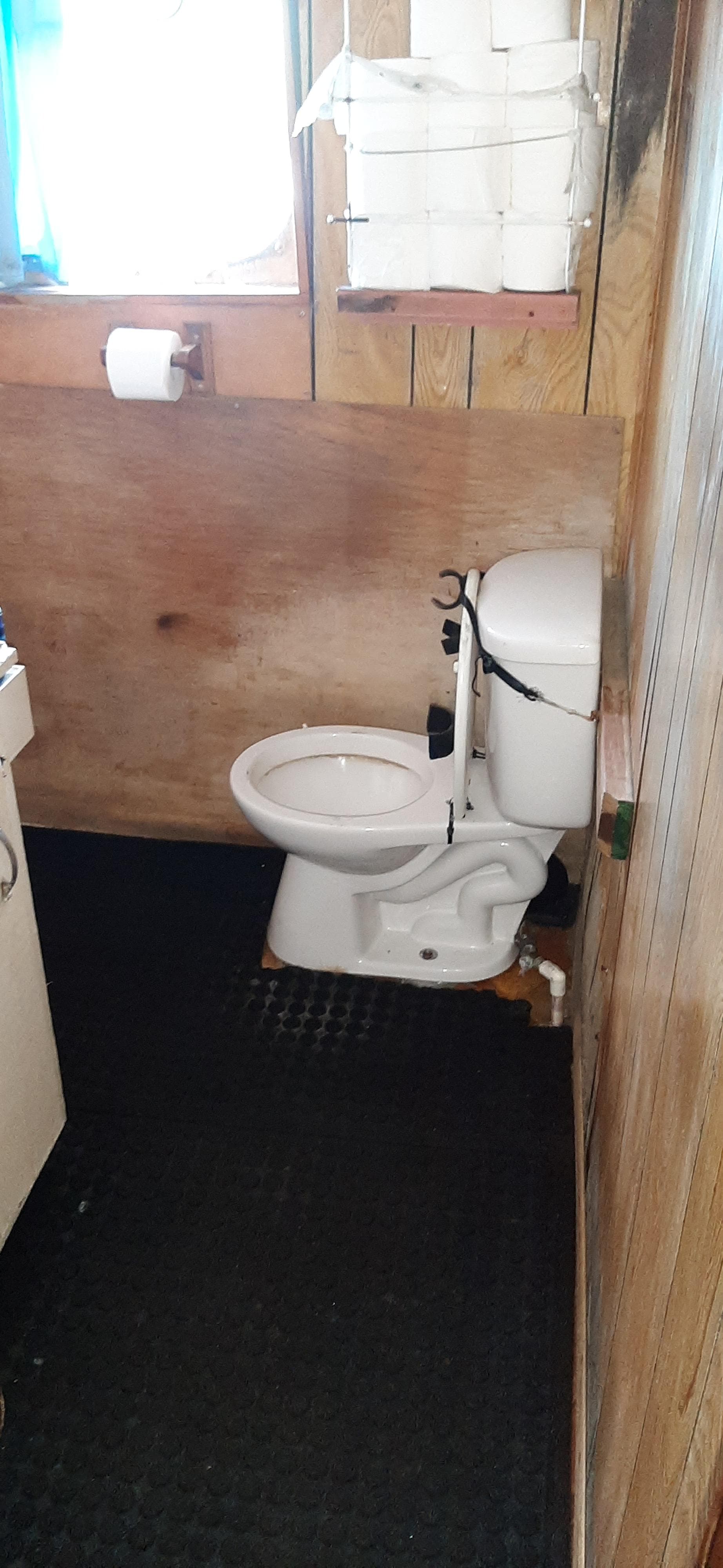 Small wooden bathroom with toilet on a 1979 Custom ALBACORE TROLLER boat.
