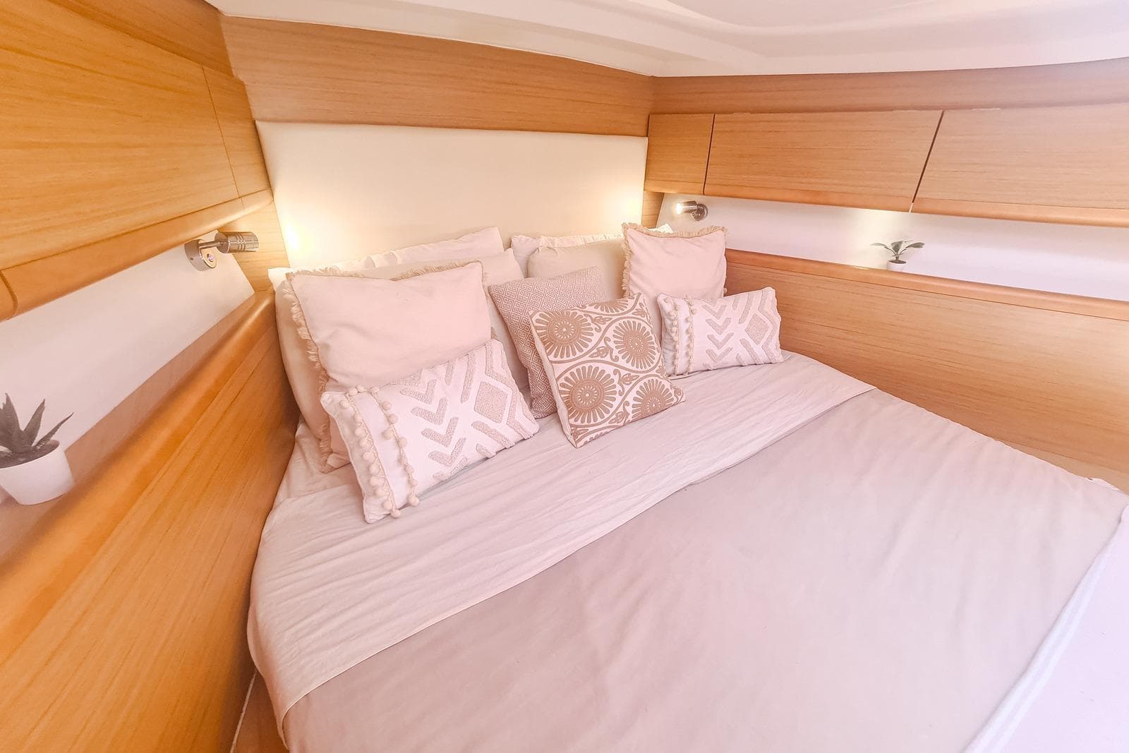 Luxurious cabin interior of 2009 Jeanneau Sun Odyssey 50 DS with elegant bedding and wood finish.