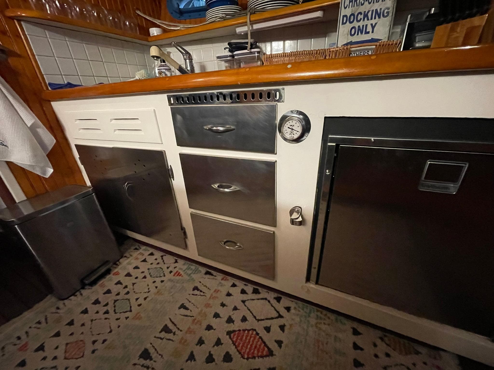 1951 Chris-Craft Catalina kitchen with vintage cabinetry and stainless steel appliances.