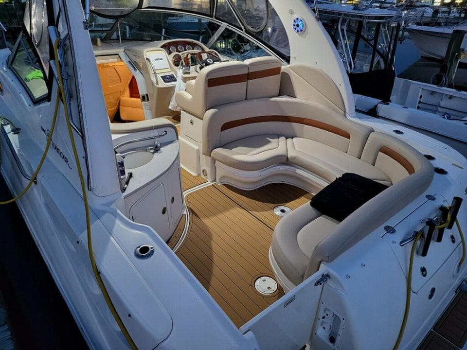 2005 Sea Ray 320 Sundancer boat interior with seating and helm station.