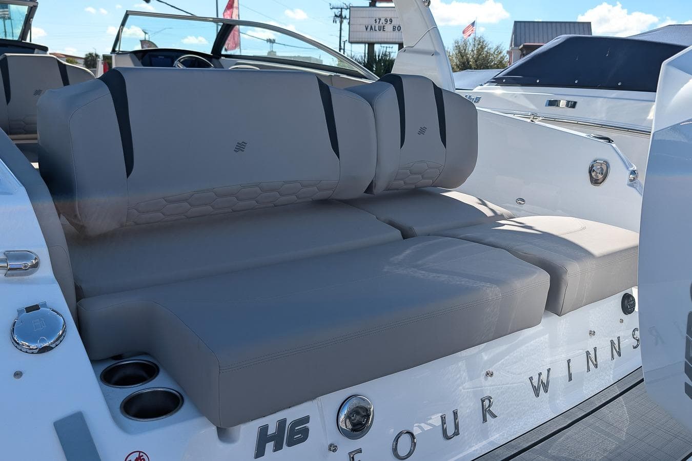 2026 Four Winns H6 OB boat interior with gray seating and cup holders.