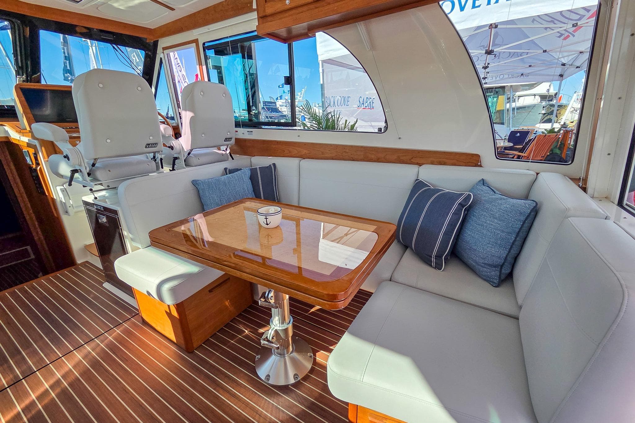 Luxurious interior of 2026 Back Cove 412 yacht with elegant seating and wooden table.