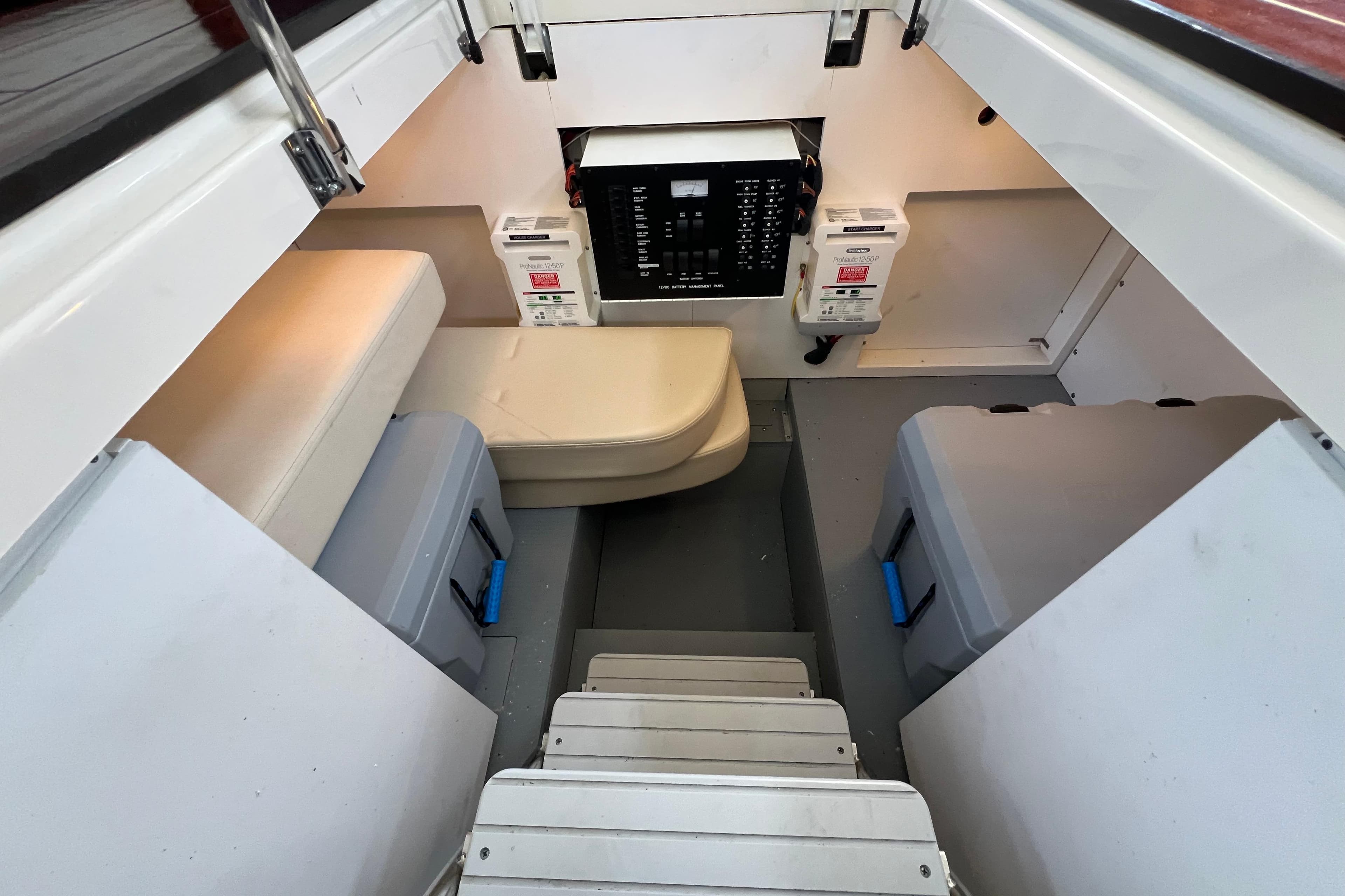 Interior of a 2013 Meridian 441 Sedan boat, featuring seating and electrical panel.