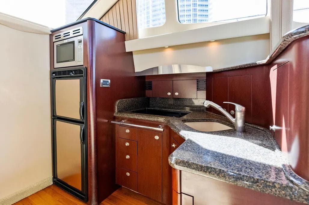 Luxurious kitchen area in 2007 Sea Ray 44 Sedan Bridge yacht with modern appliances.