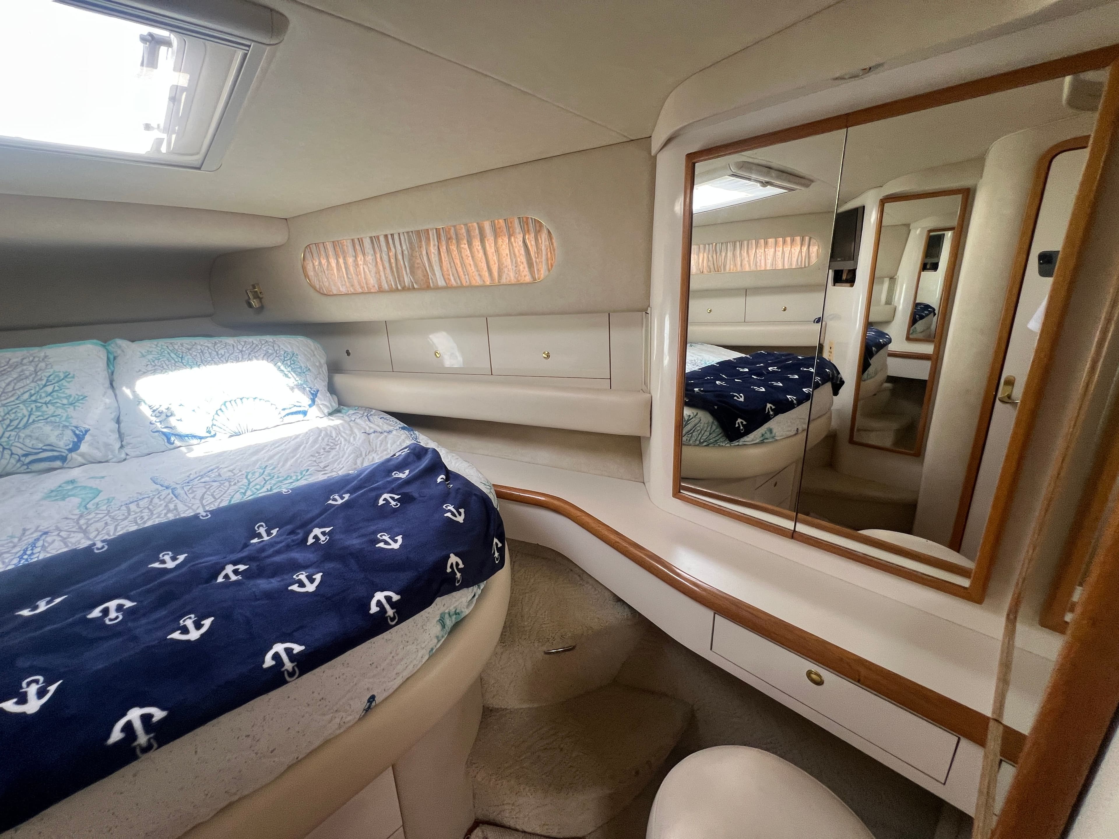 Interior of a 1997 Sea Ray 450 yacht featuring a cozy bedroom.