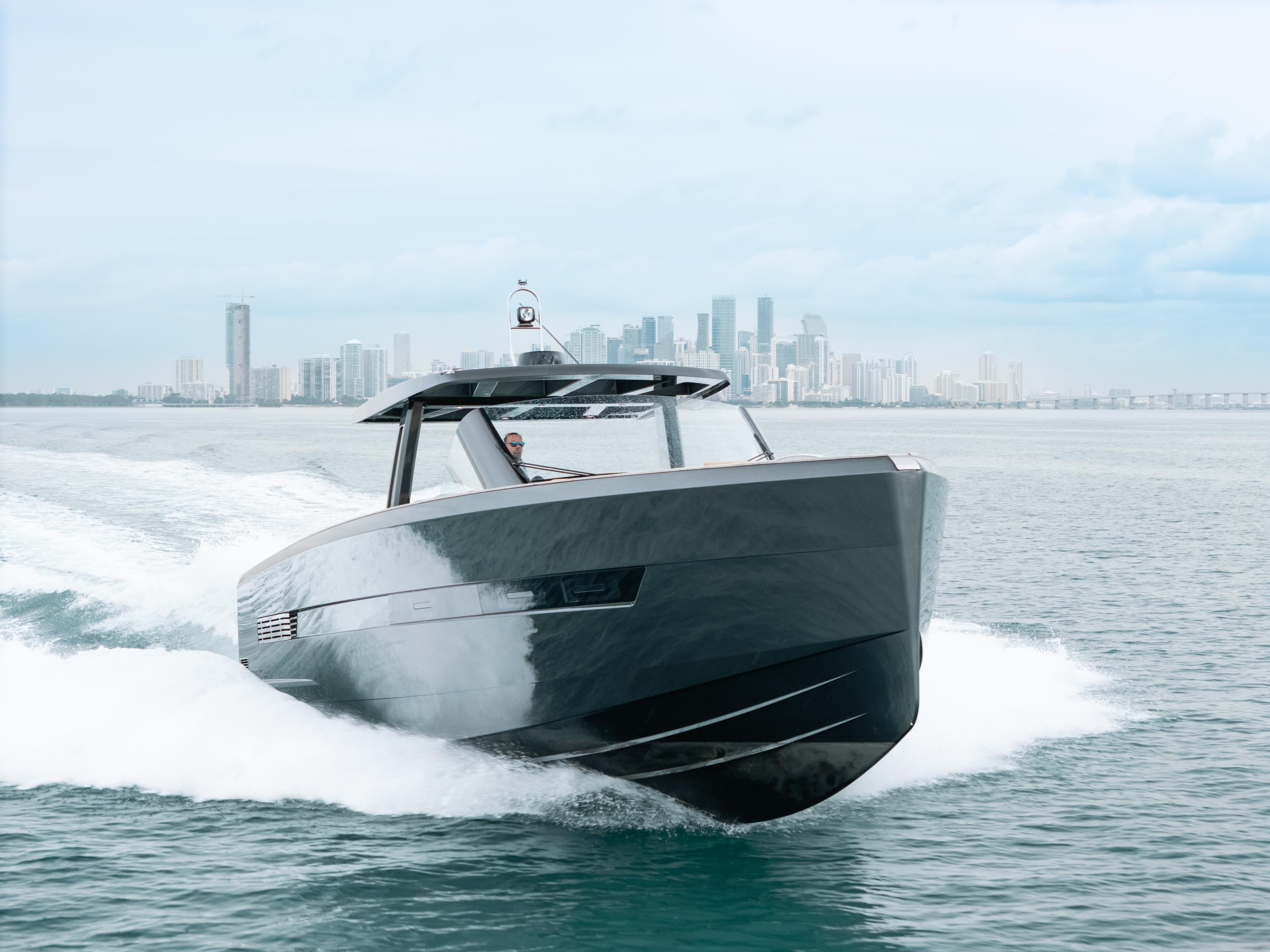 2022 Fjord 52 Open yacht cruising near city skyline on a clear day.