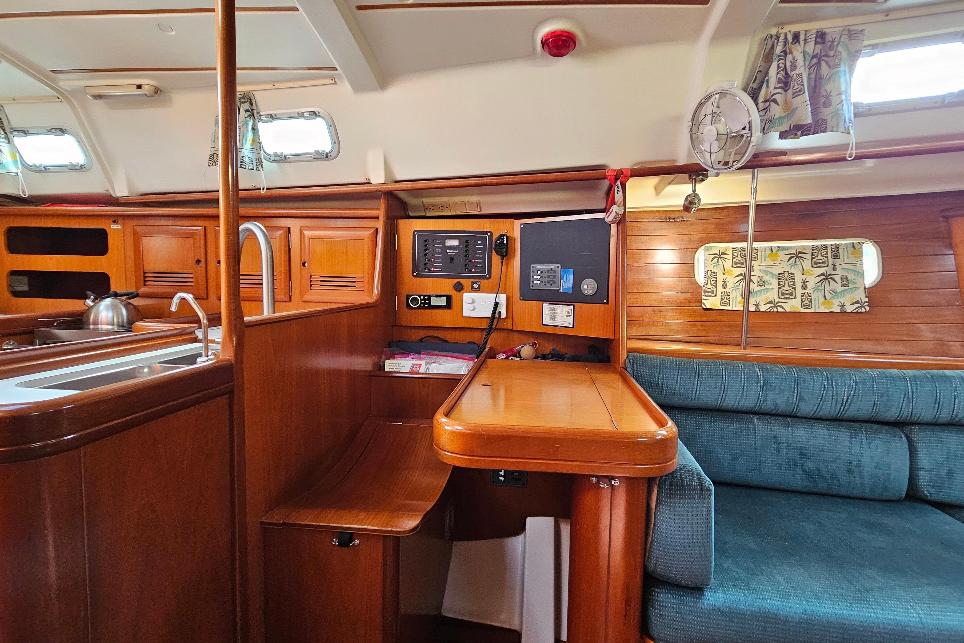 Interior of 2000 Beneteau Oceanis Clipper 361 yacht with wood finish and seating area.