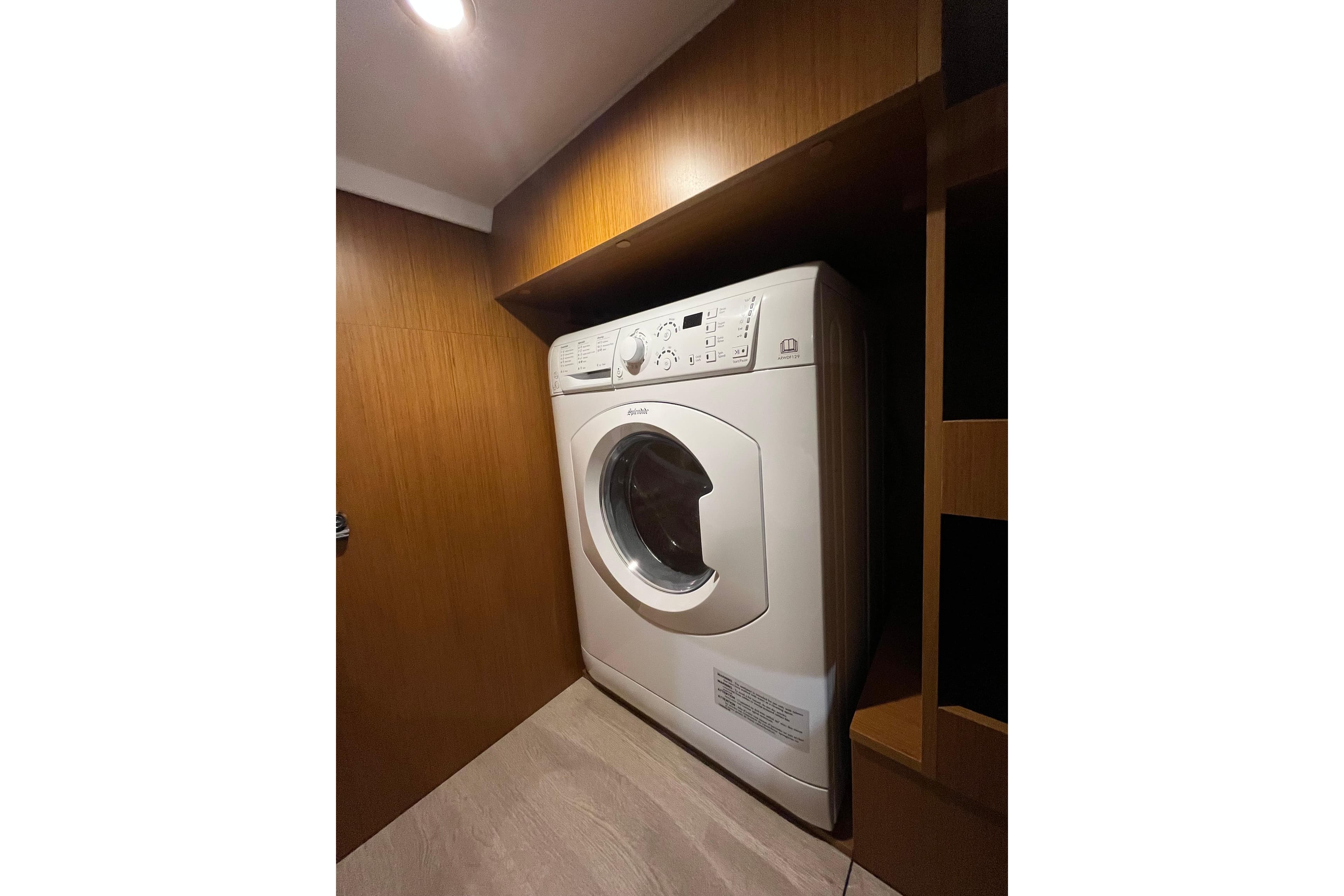 Laundry area with washing machine in 2026 Beneteau 41 Swift Trawler Sedan.