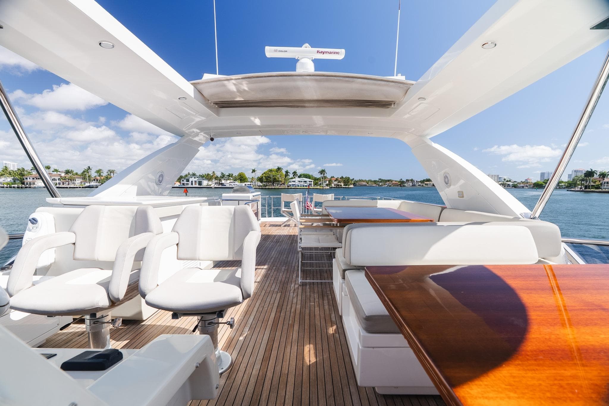 Luxurious 2017 Azimut Fly 72 yacht interior with elegant seating and scenic waterfront view.