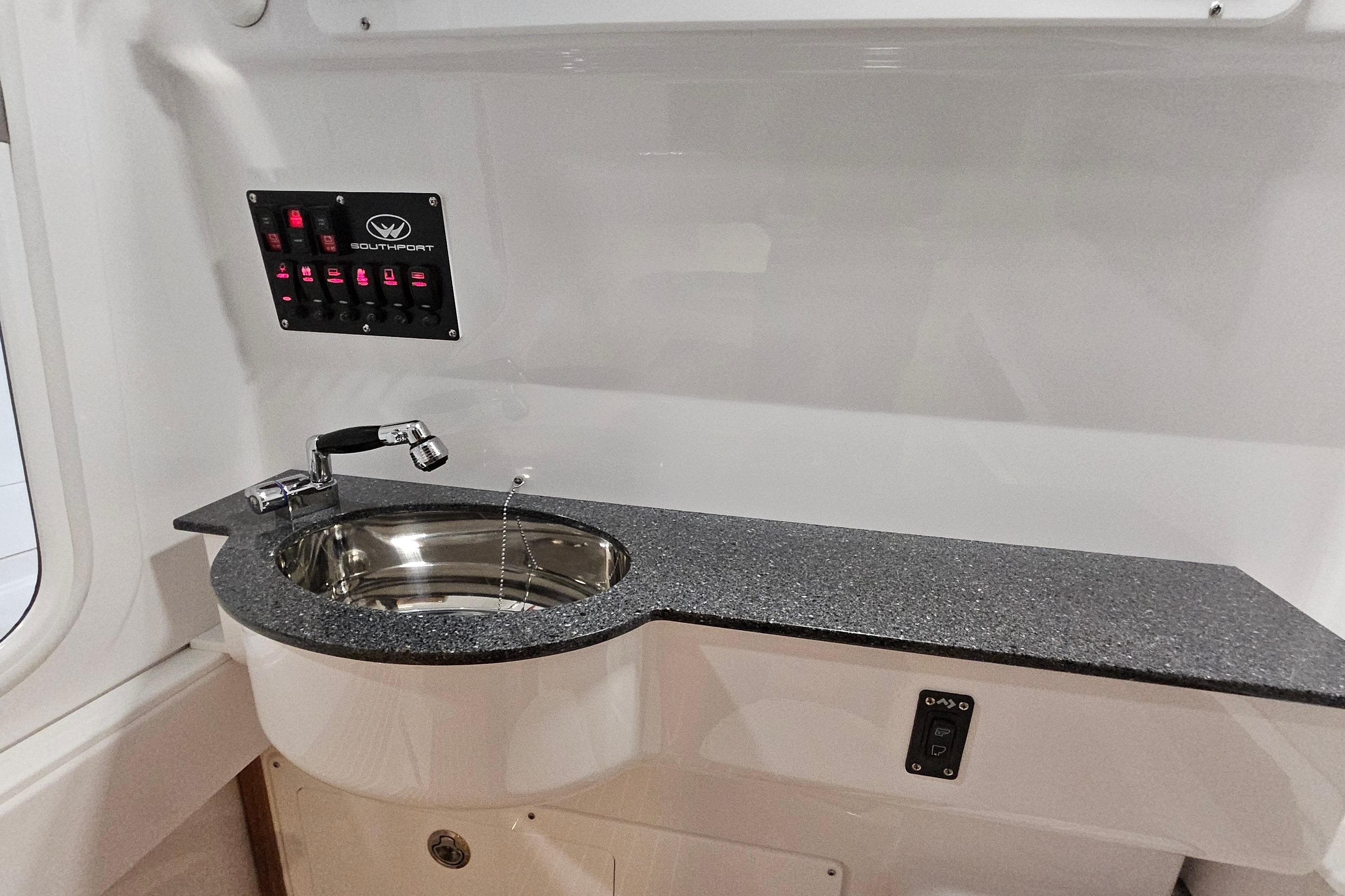 2026 Southport 30 FE boat interior with sink and control panel.