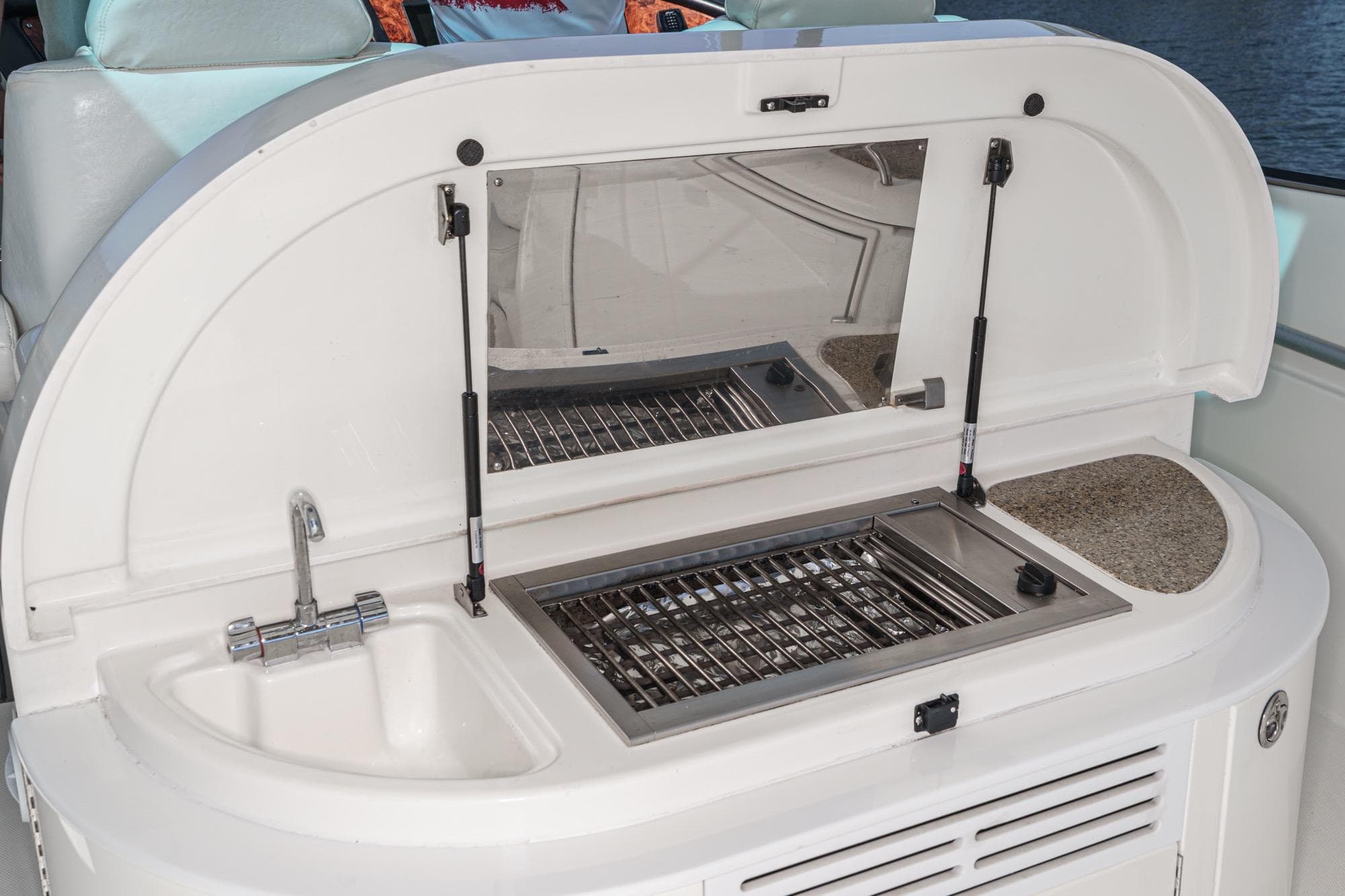 2004 Cruisers Yachts 540 Express boat interior with sink and grill setup.