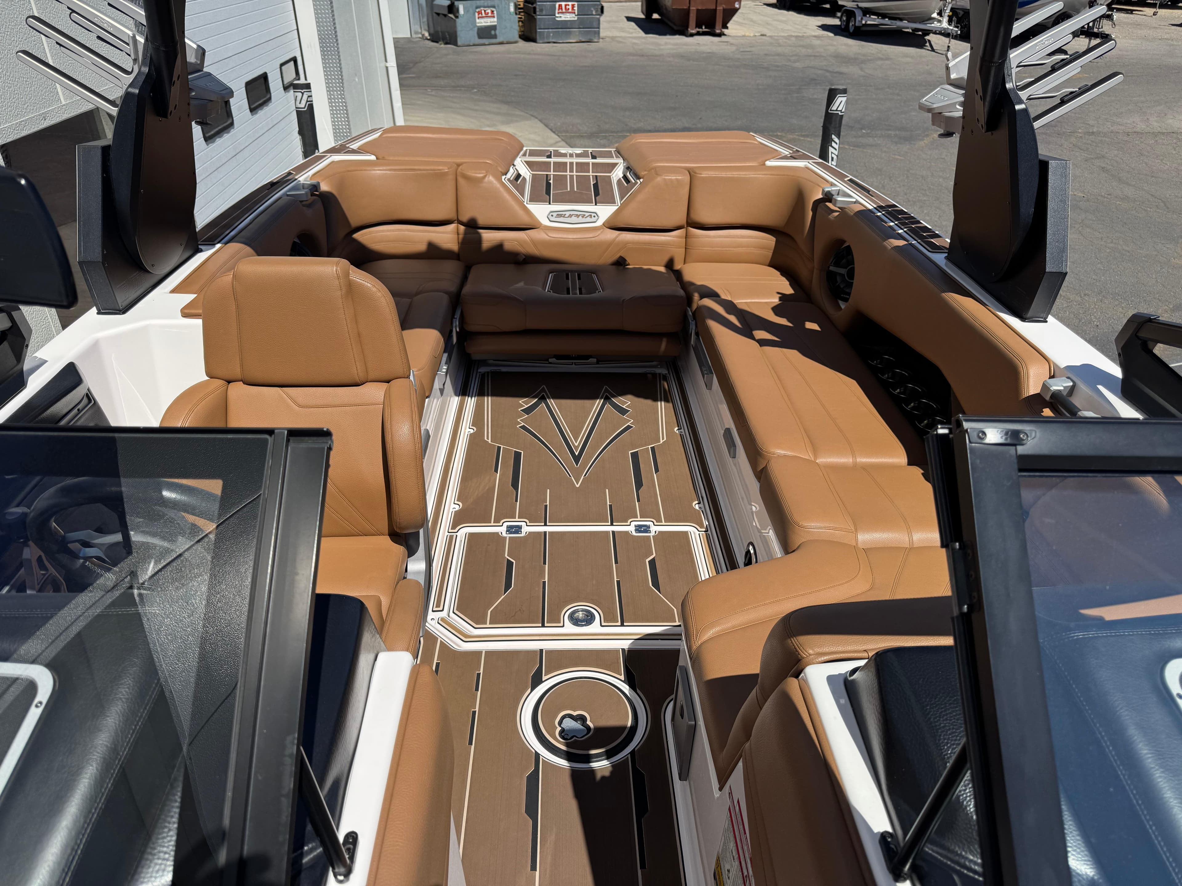 Luxurious 2021 Supra SL 550 boat interior with tan leather seating and sleek design.