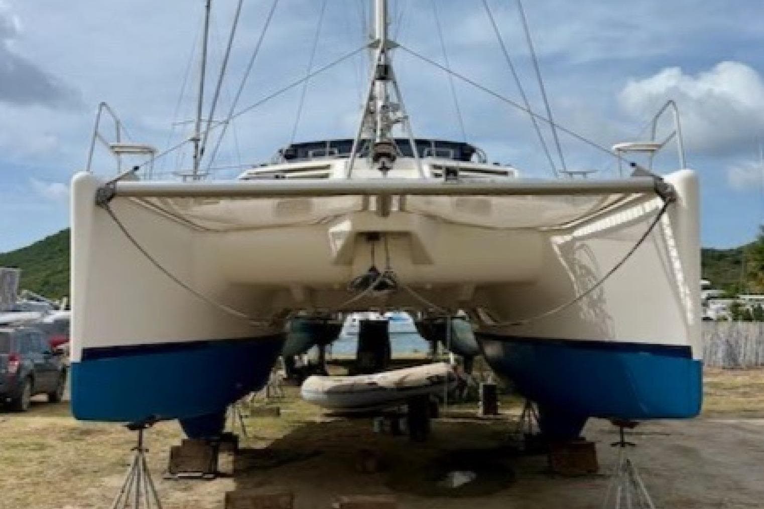 Front view of a 2001 Leopard 38 catamaran on land, showcasing its twin hulls.