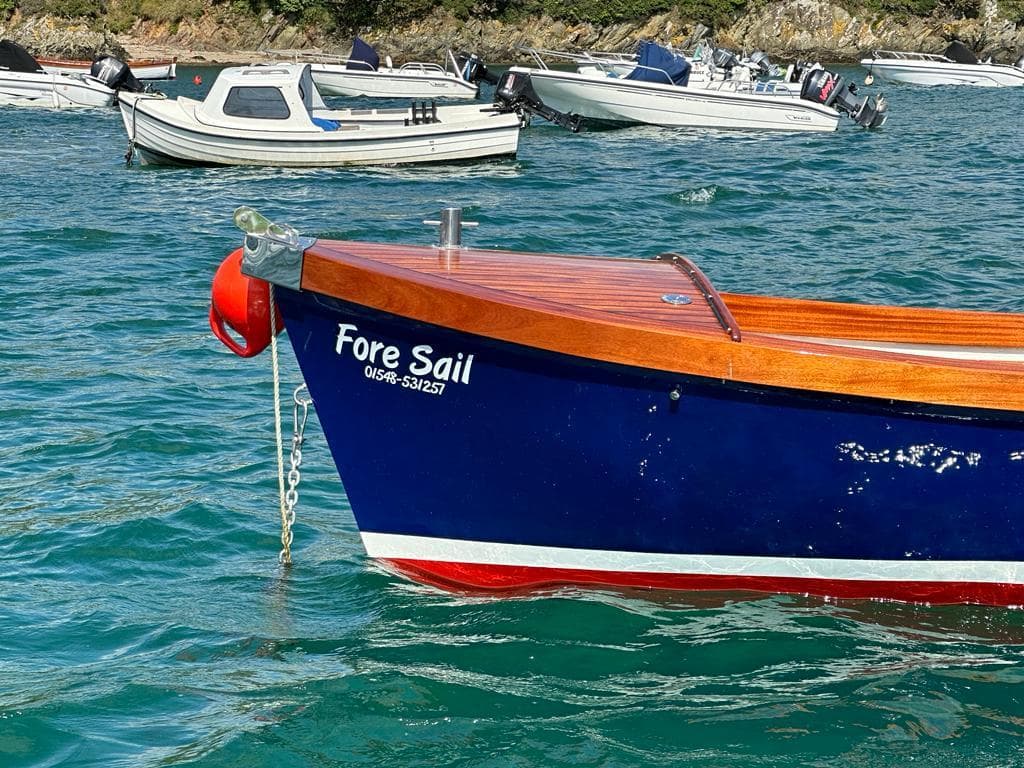 Blue Nelson 18 boat named "Fore Sail" on water, surrounded by other boats, 2023 model.