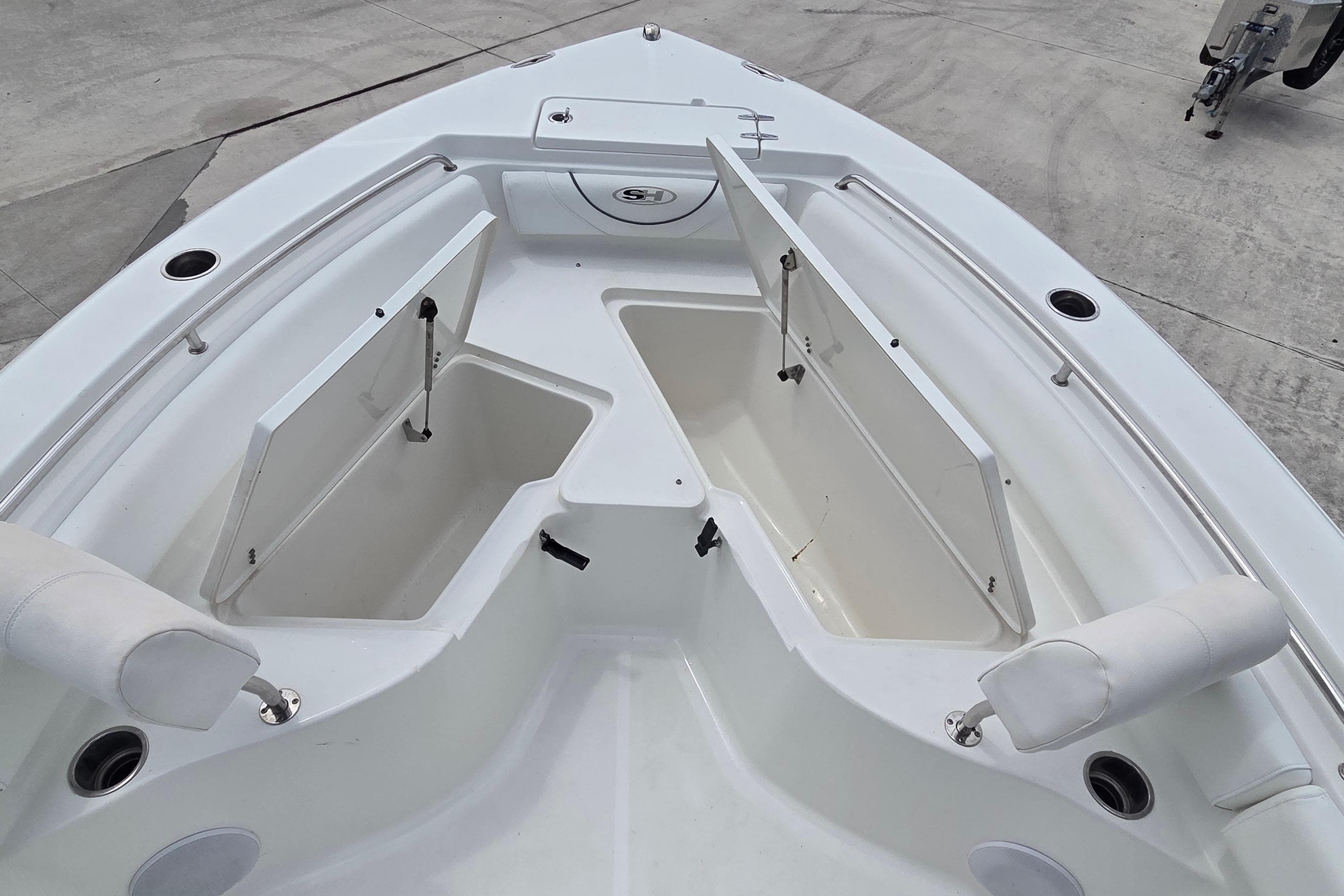 2017 Sea Hunt Ultra 225 boat with open storage compartments on deck.