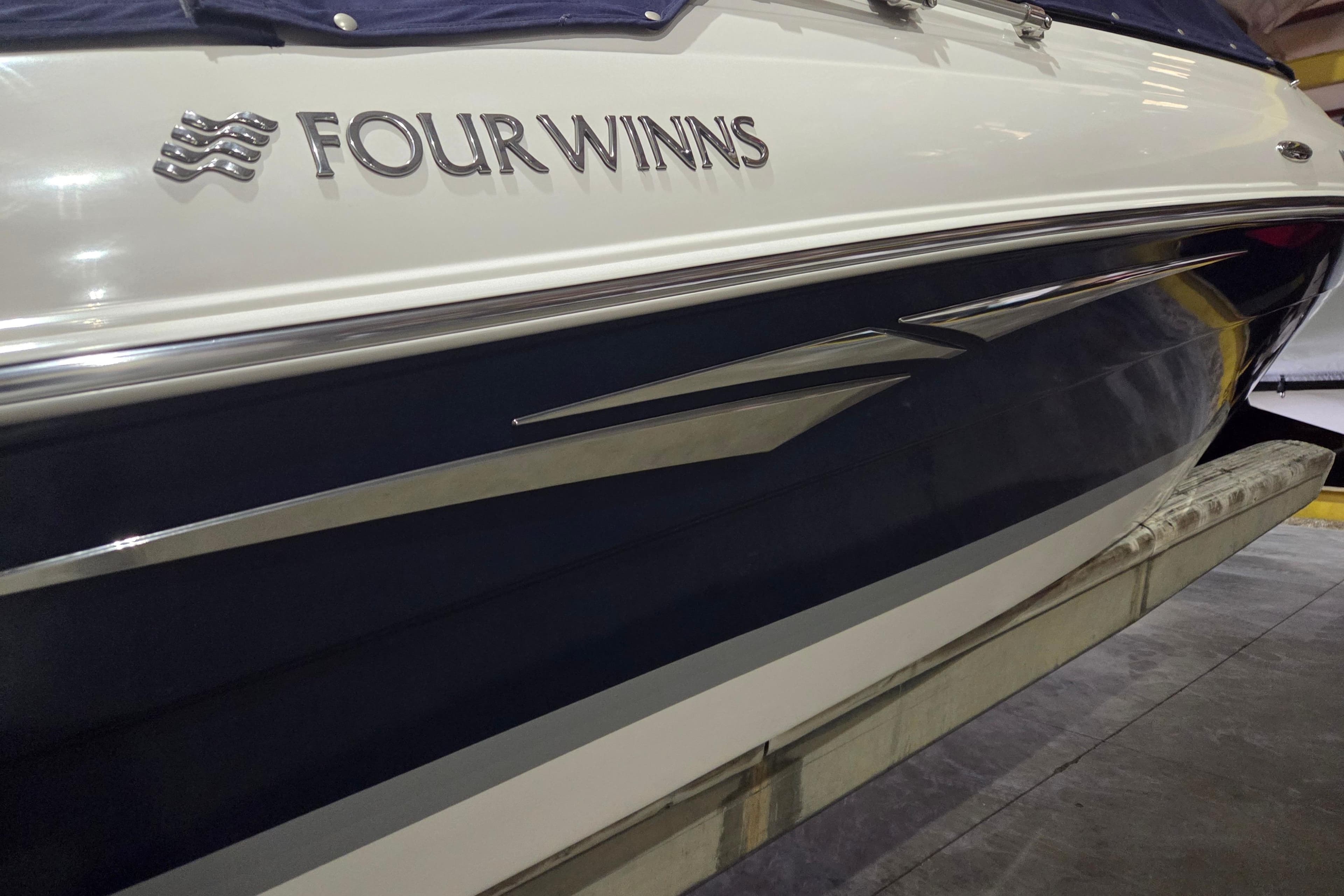 2014 Four Winns 190 Horizon boat side view with logo and sleek design.