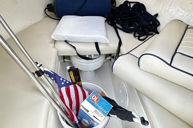 2022 Rossiter R23 Picnic Boat interior with American flag, cushions, and nautical equipment.
