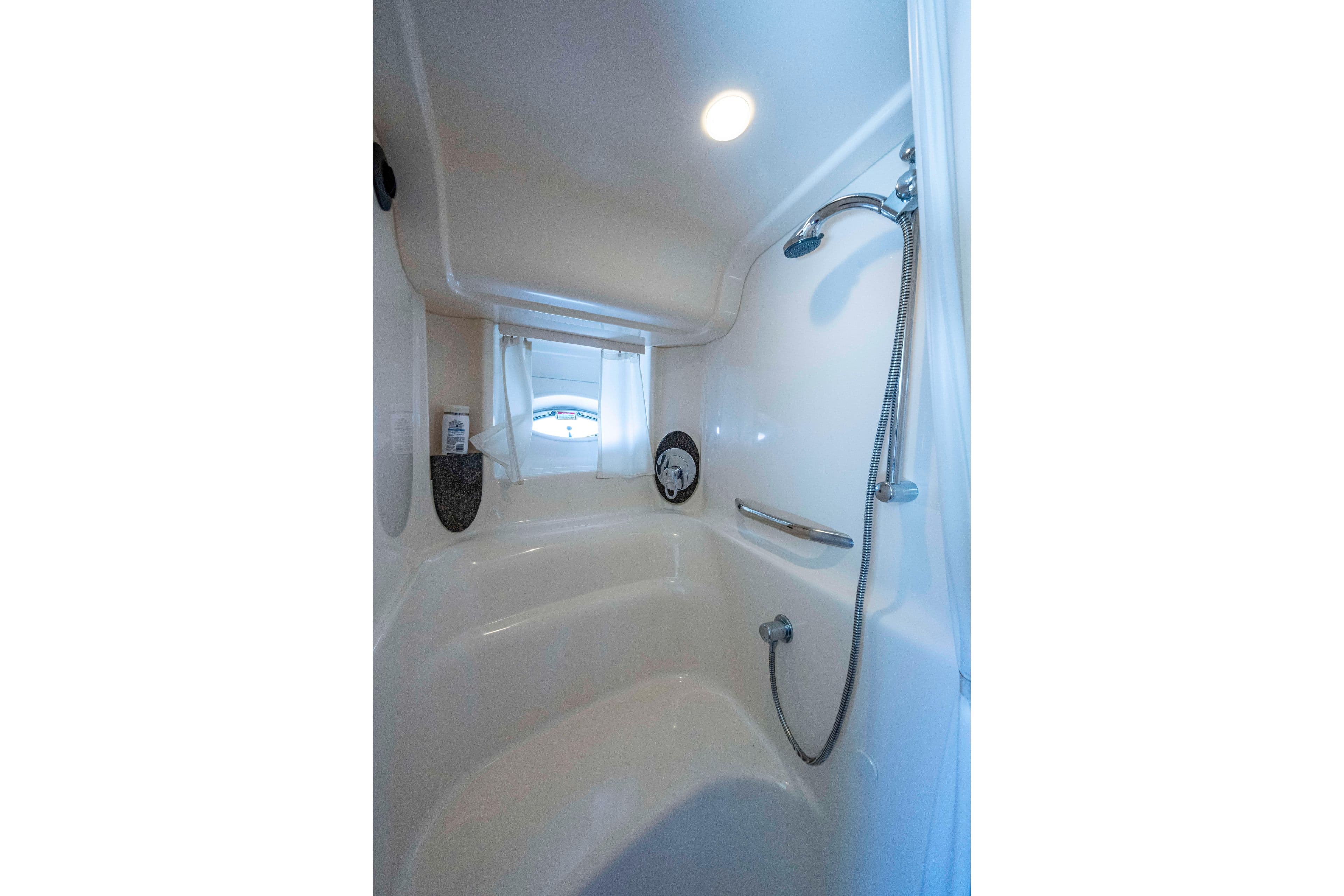 Luxurious bathroom interior of 2005 Sea Ray 420 Sundancer yacht with shower and window.
